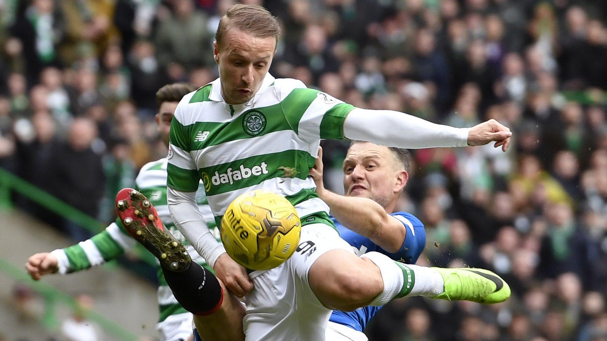 Celtic's Leigh Griffiths tumbles in the box after a challenge from Rangers' Clint Hill