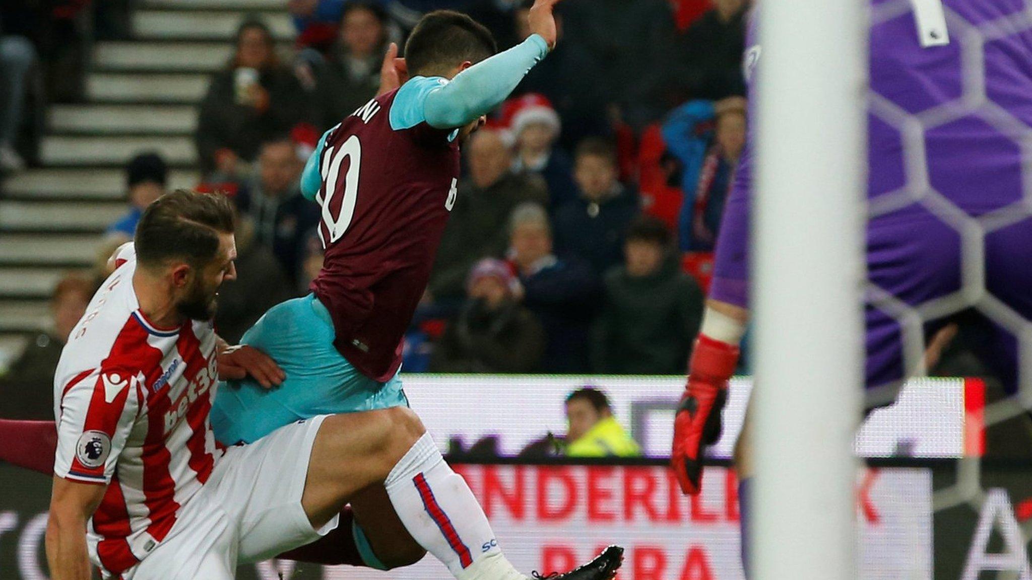 West Ham forward Manuel Lanzini falls over as he is tackled by Stoke defender Erik Pieters