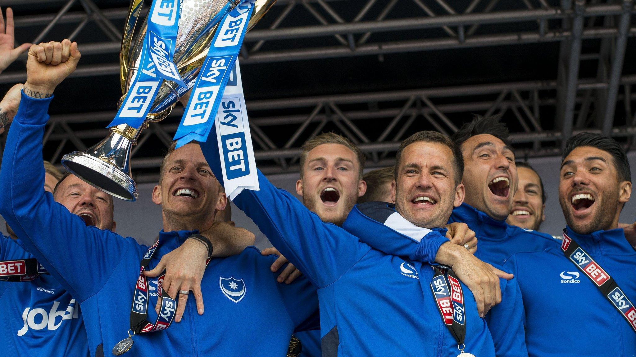 Portsmouth players lift the League Two trophy at a civic reception in Southsea