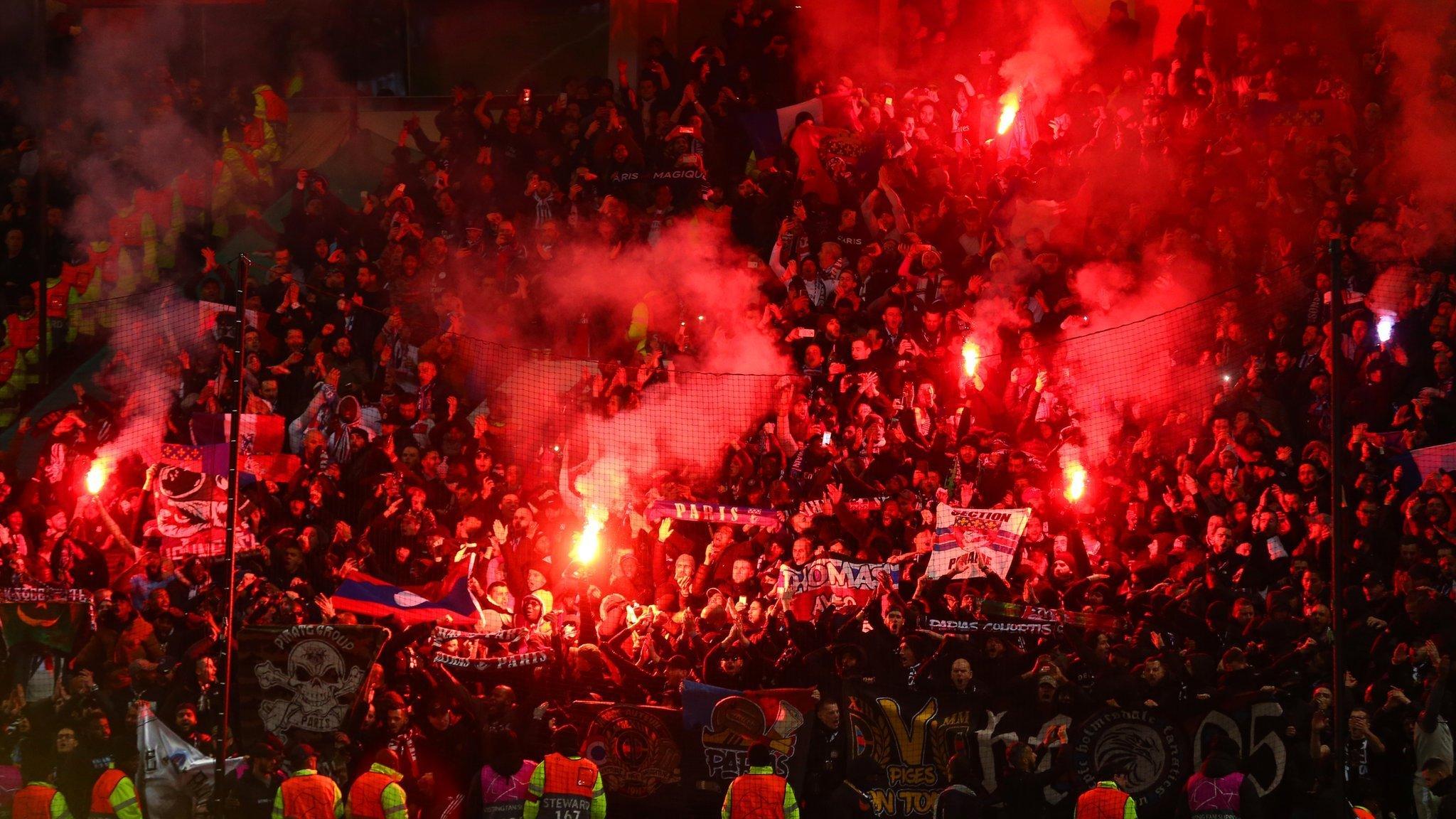 PSG fans holding flares at Old Trafford