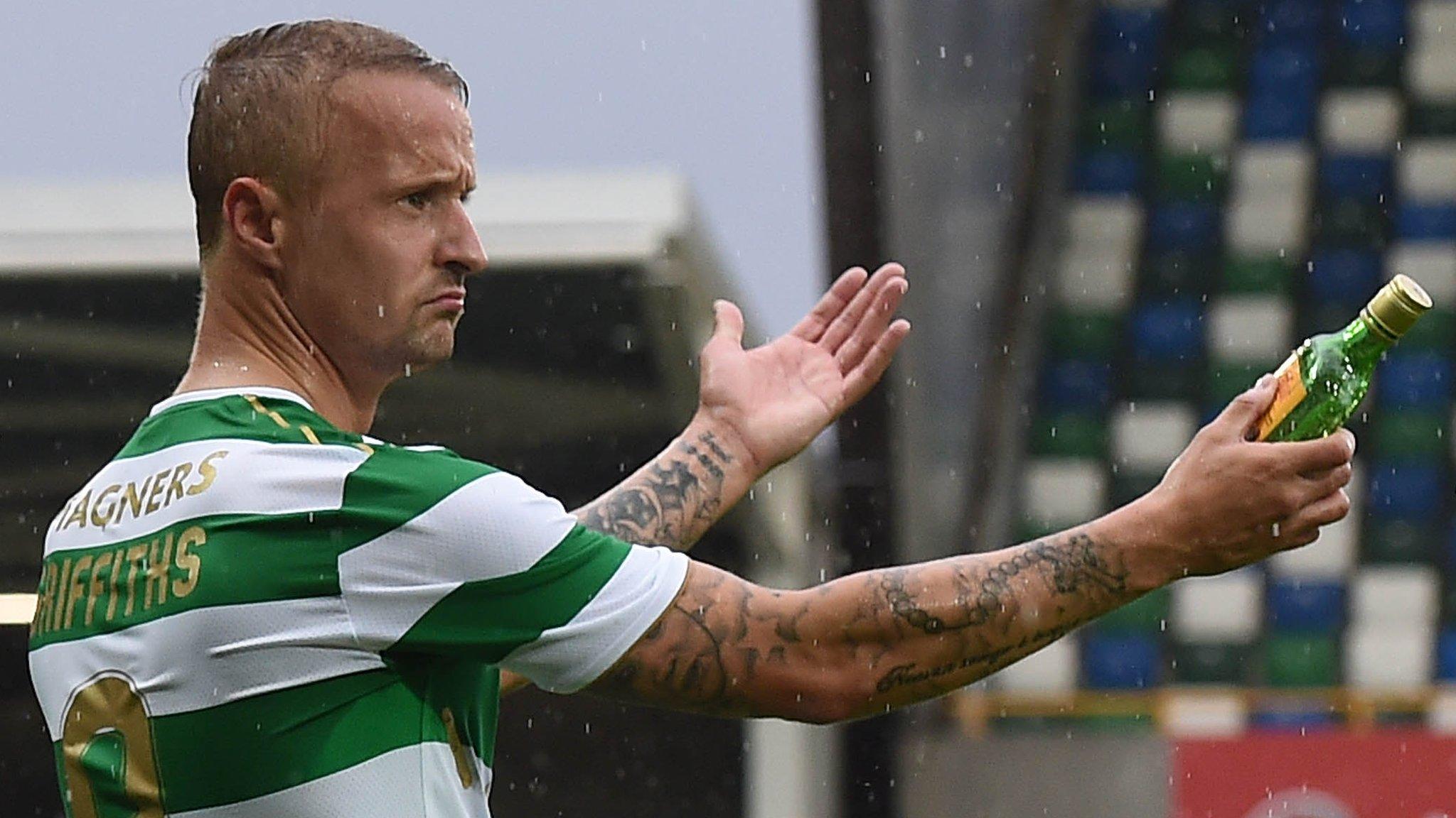 Leigh Griffiths shows the bottle to the referee