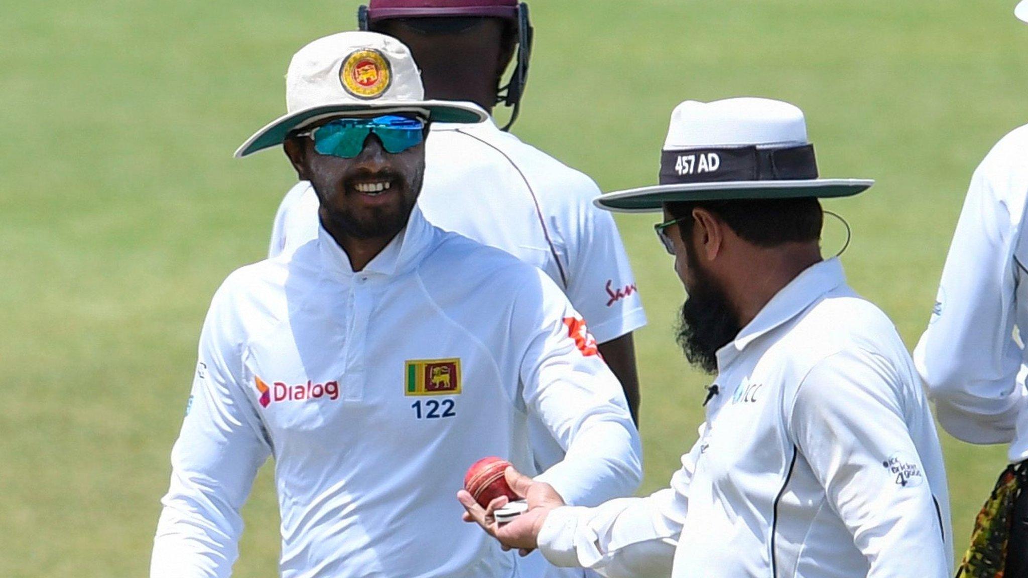 Sri Lanka captain Dinesh Chandimal receives the ball from umpire Aleem Dar