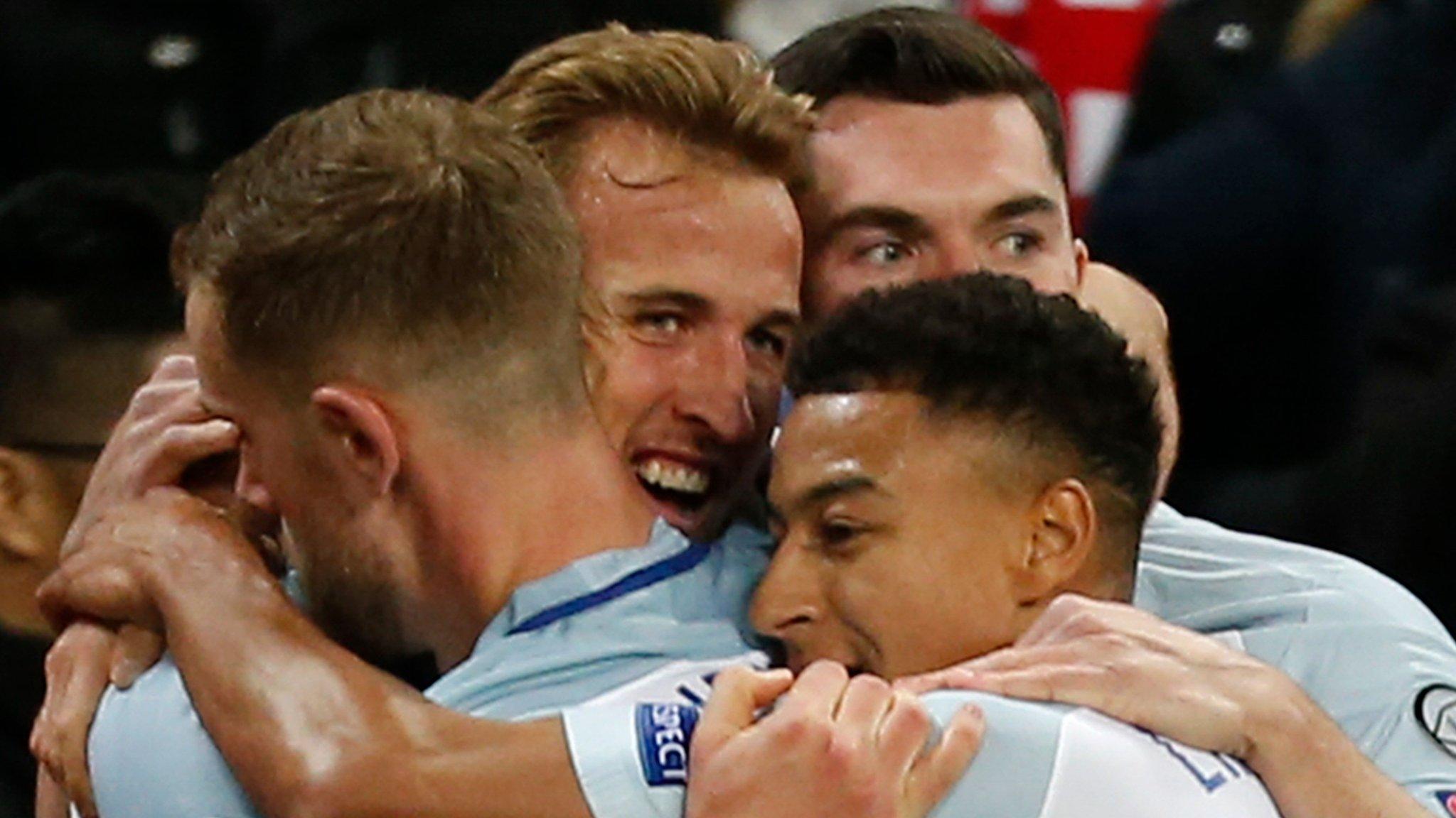 England players celebrate scoring a goal against Slovenia in a World Cup qualifier