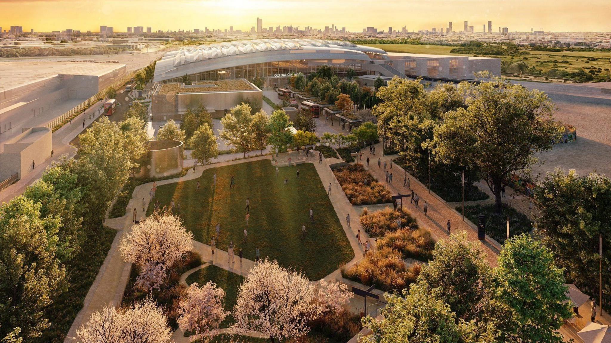 An artist's impression of the new HS2 Old Oak Common station, with a large glass and steel building in the background, surrounded by areas of grass and trees