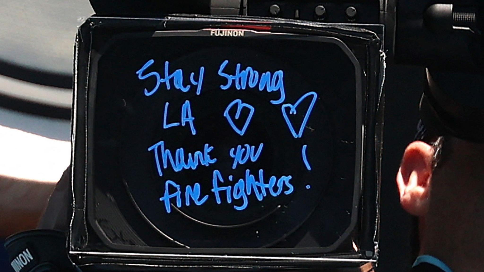 A message reading 'Stay strong LA, thank you firefighters' written on a camera lens by Coco Gauff at the Australian Open