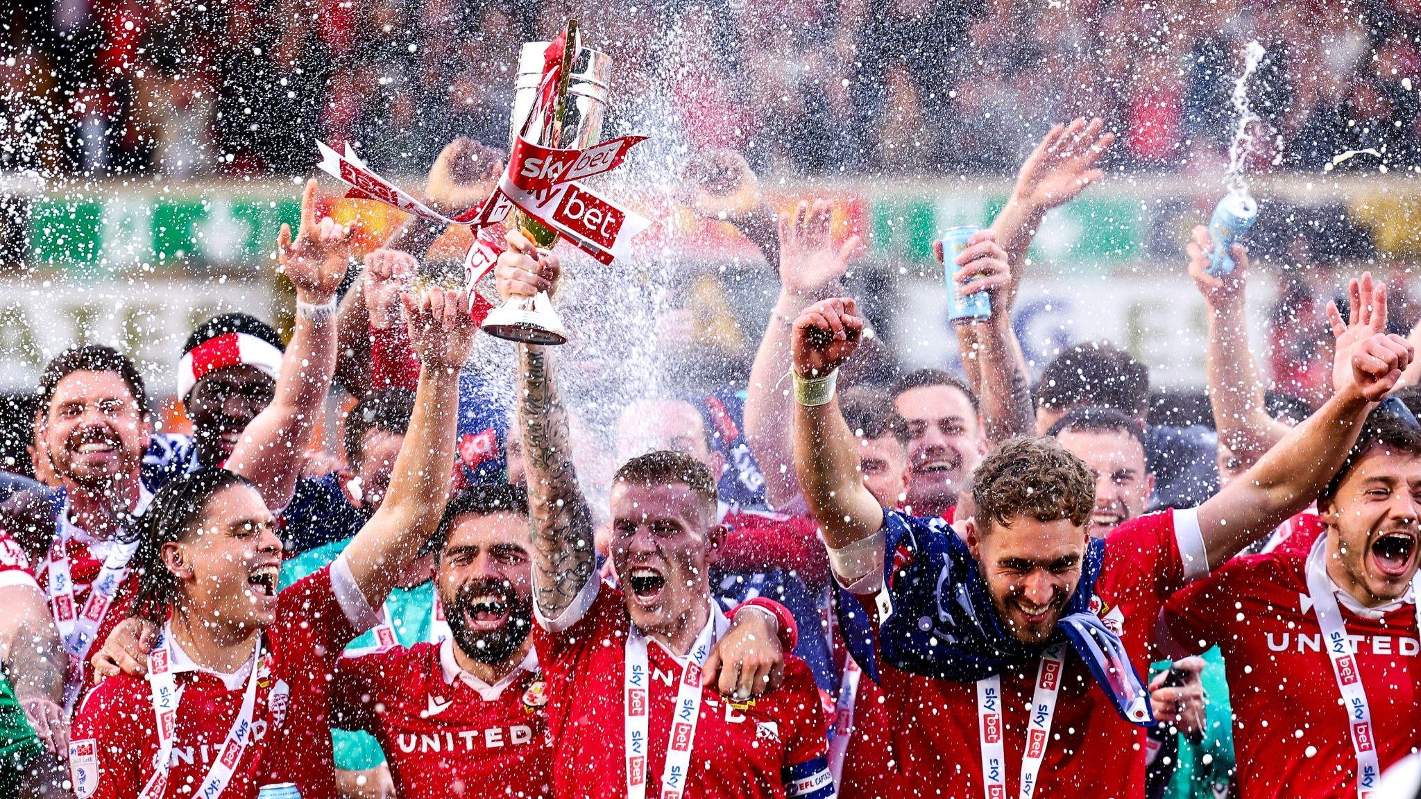 James McClean of Wrexham celebrates winning promotion to the championship with team mates