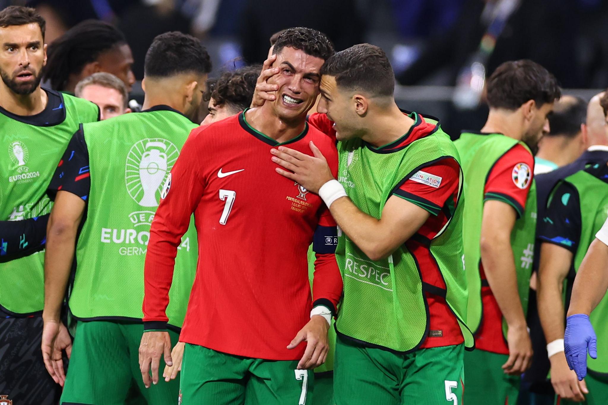 Cristiano Ronaldo is consoled by Portugal team-mate Diogo Dalot after missing a penalty in the last-16 match against Slovenia at Euro 2024