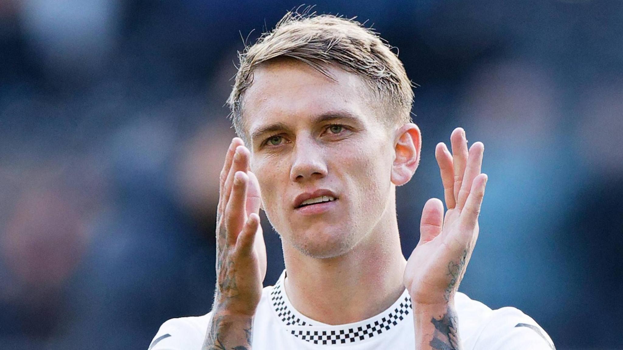 Ethan Galbraith applauds after a Swansea game last season