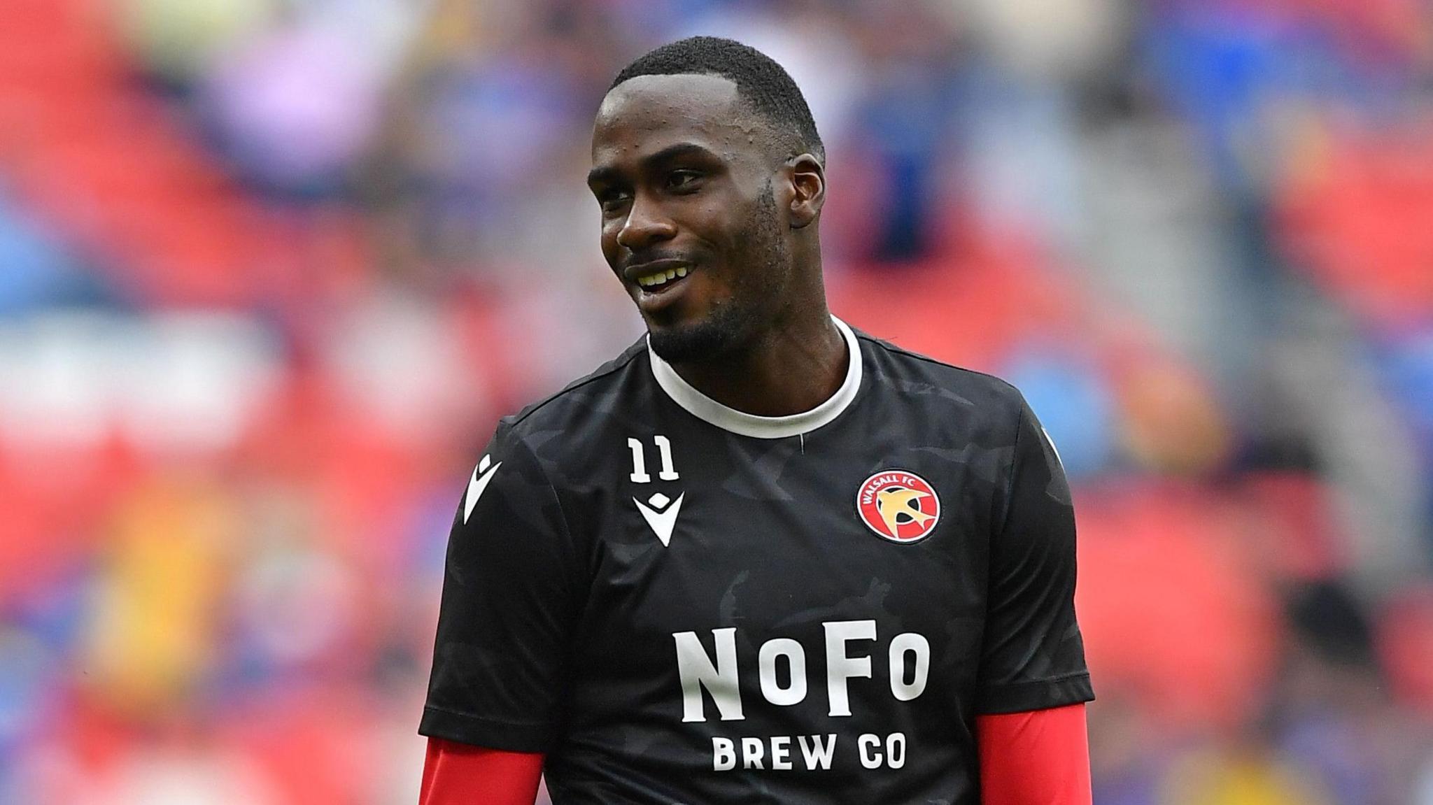 Levi Amantchi warming up ahead of the 2025 League Two play-off final for Walsall