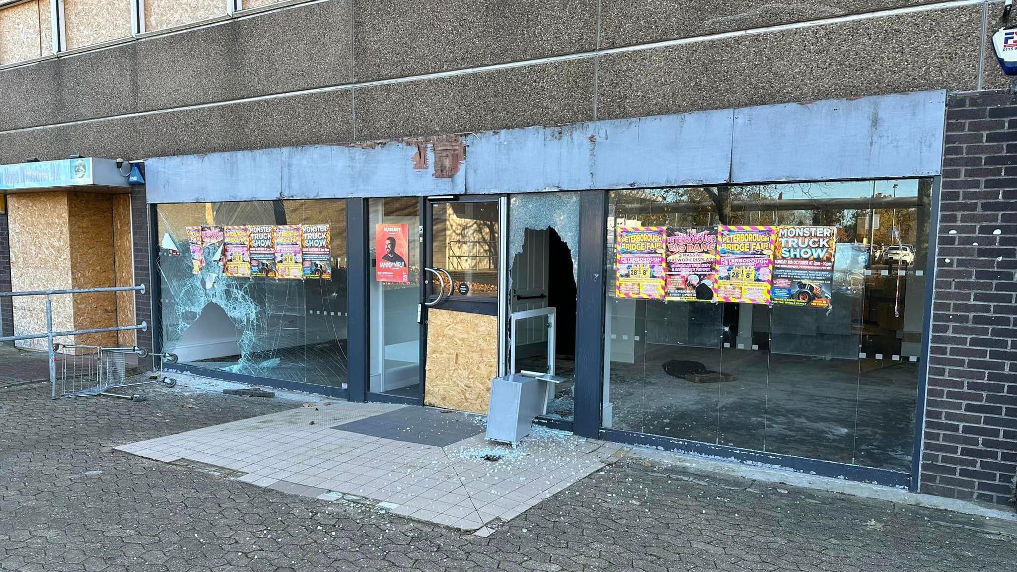 Vandalised shop unit with broken windows 