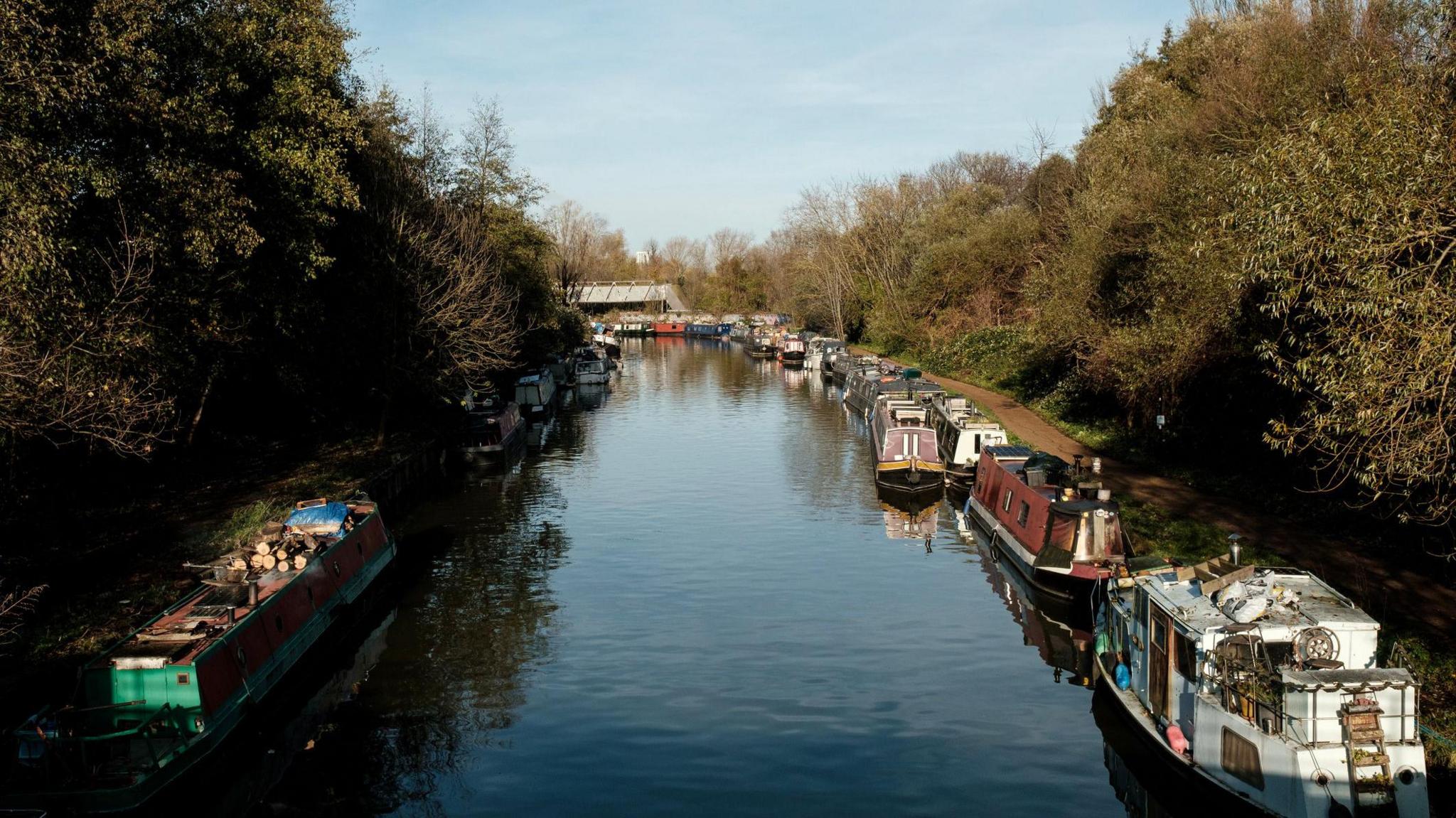 A file image of narrow boats moored along the banks of the River Lea in north-east London.