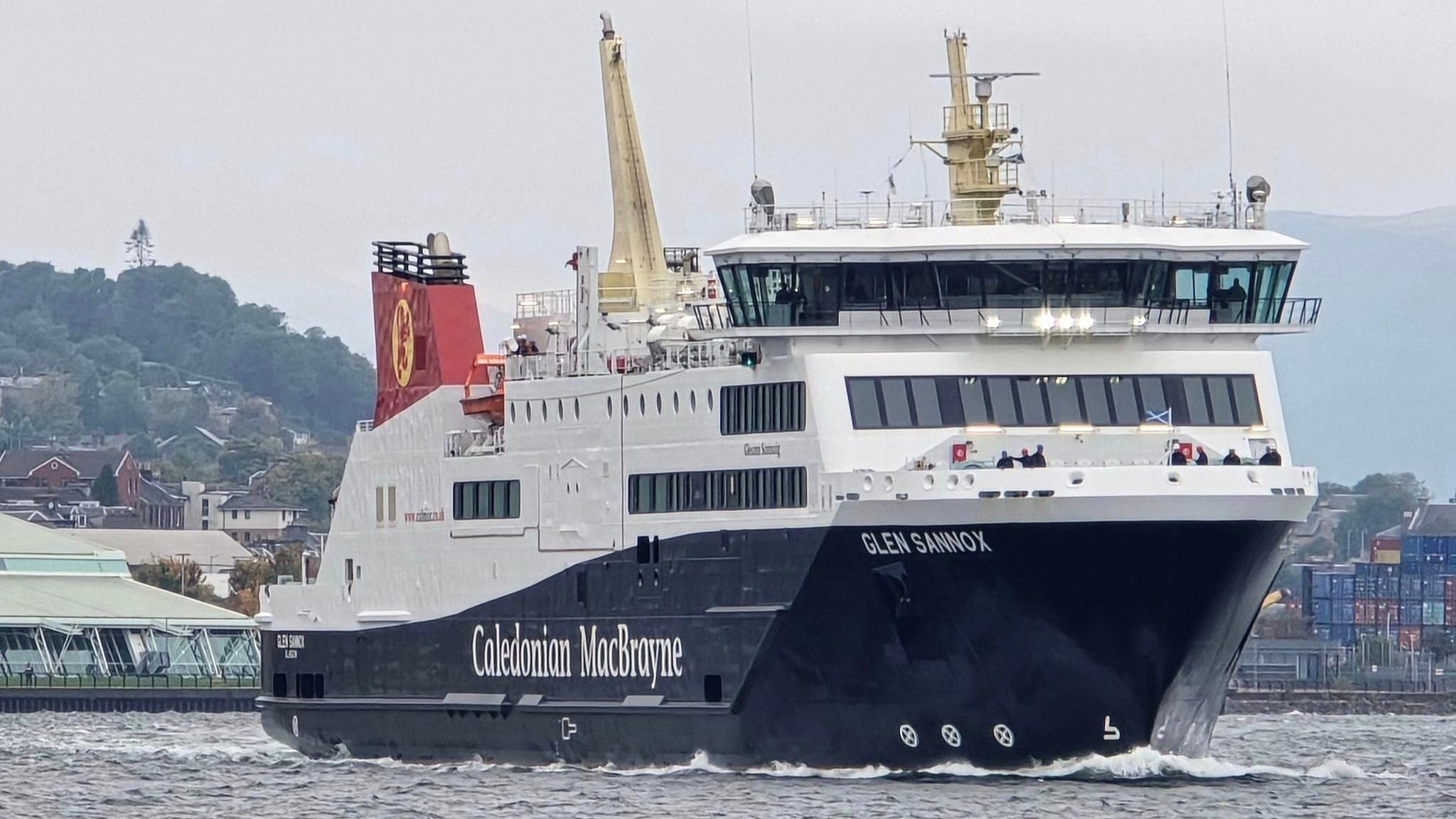 Glen Sannox, a black and white ship with red funnels is pictured on the River Clyde, heading at a diagonal angle towards the camera