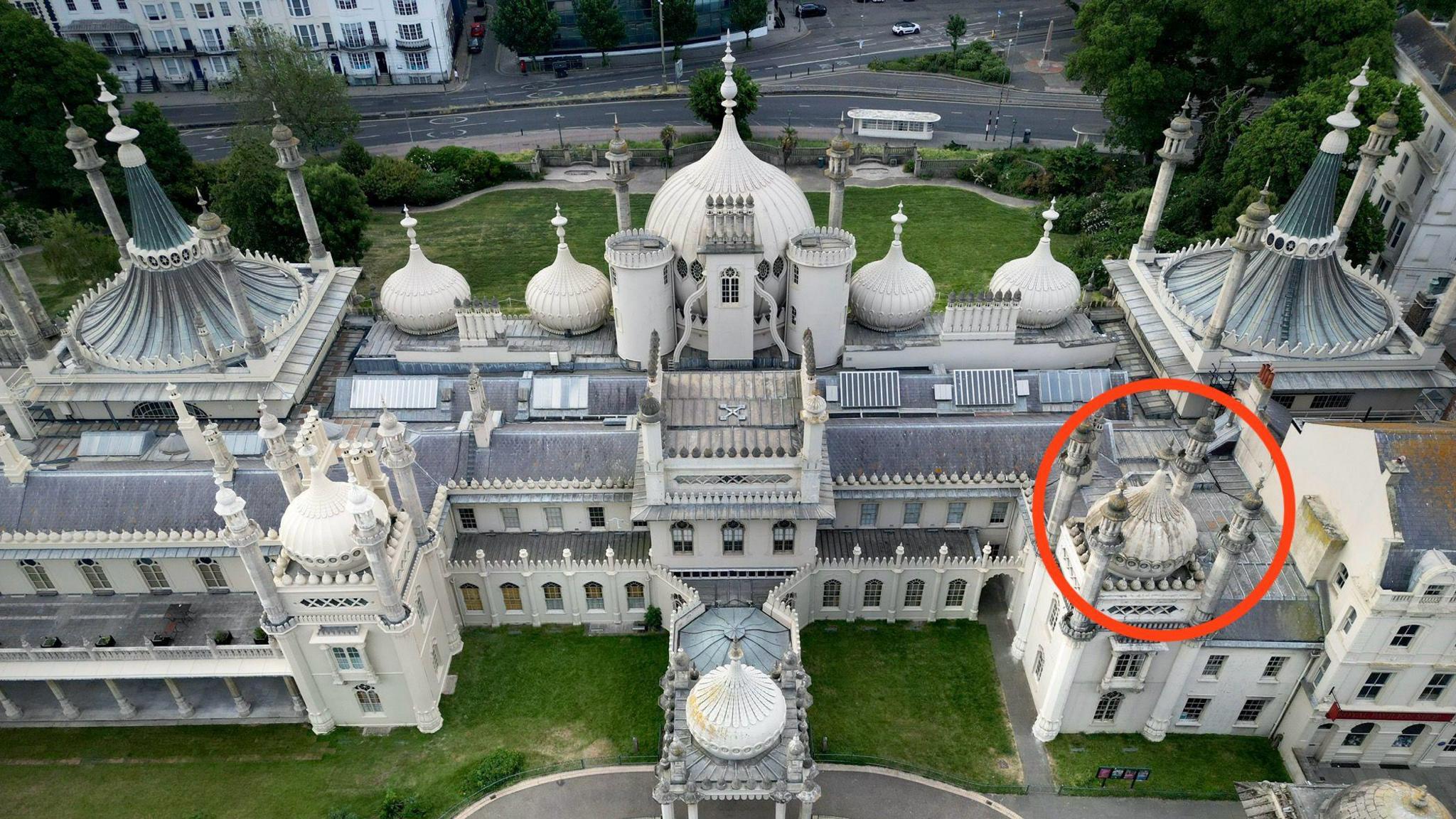 An aerial view of Brighton's Royal Pavilion. There is a red circle around one of the pavilion's onion-shaped roof domes