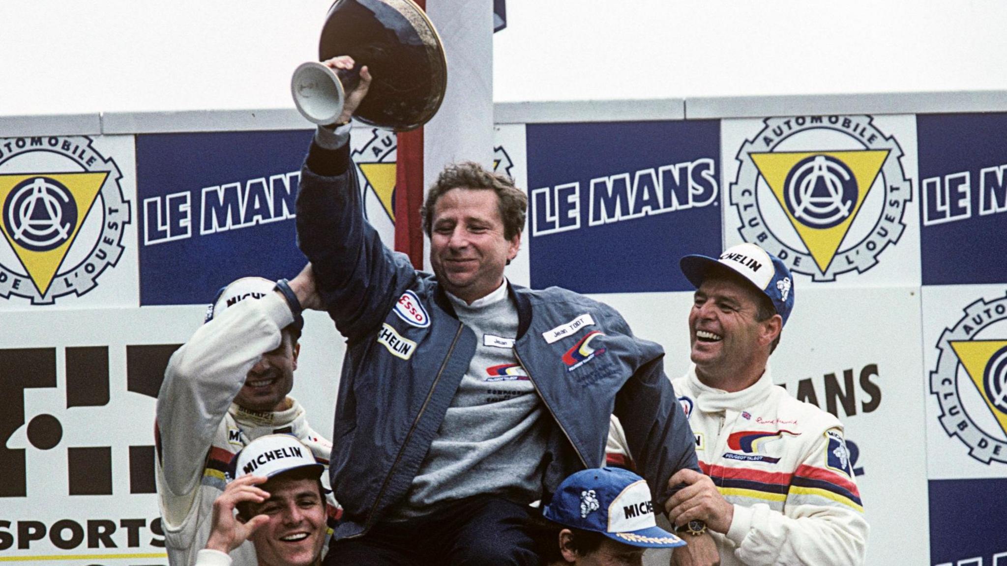 Warwick (right) helps lift Jean Todt as Peugeot celebrate victory in the Le Mans 24 hour race in 1992