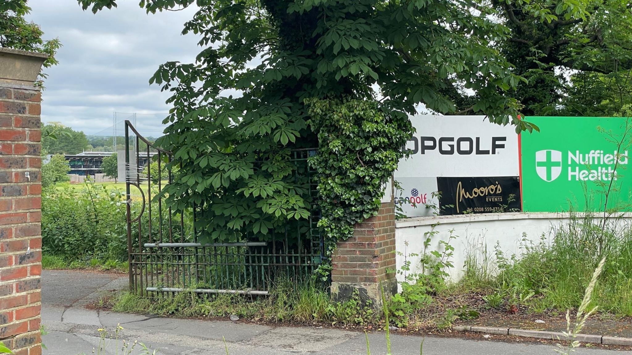 The entrance driveway to Topgolf, with the range seen in the background