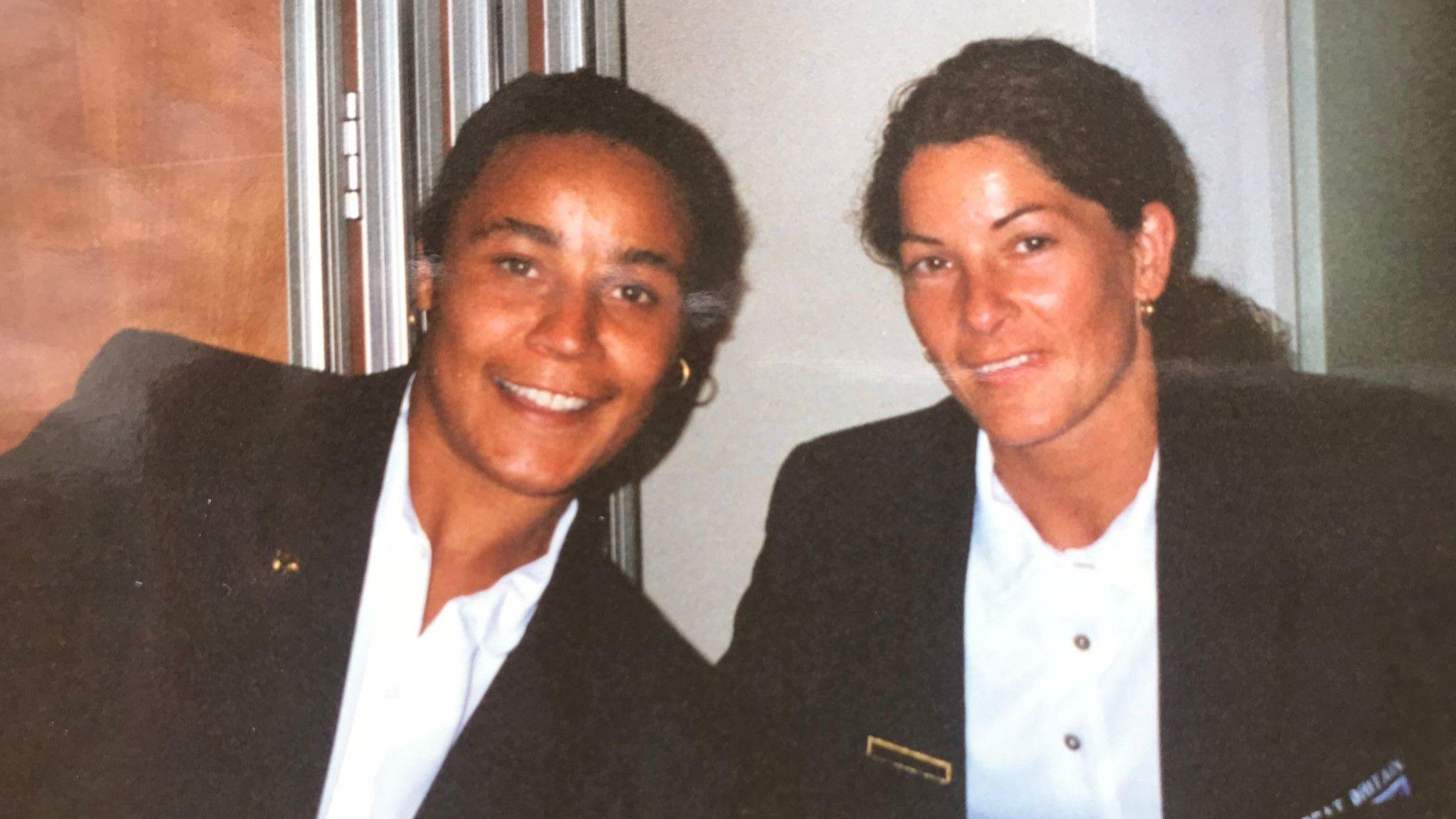 Lisa McIntosh and Brenda Dobek, in their Great Britain suits, smile for a photograph