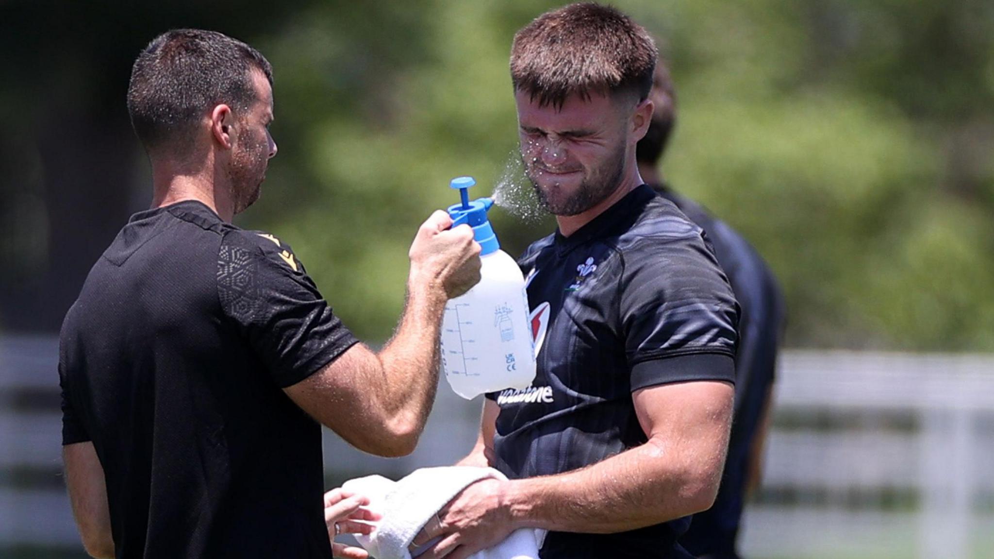 Wales centre Joe Roberts is kept refreshed during training with water squirted in his face