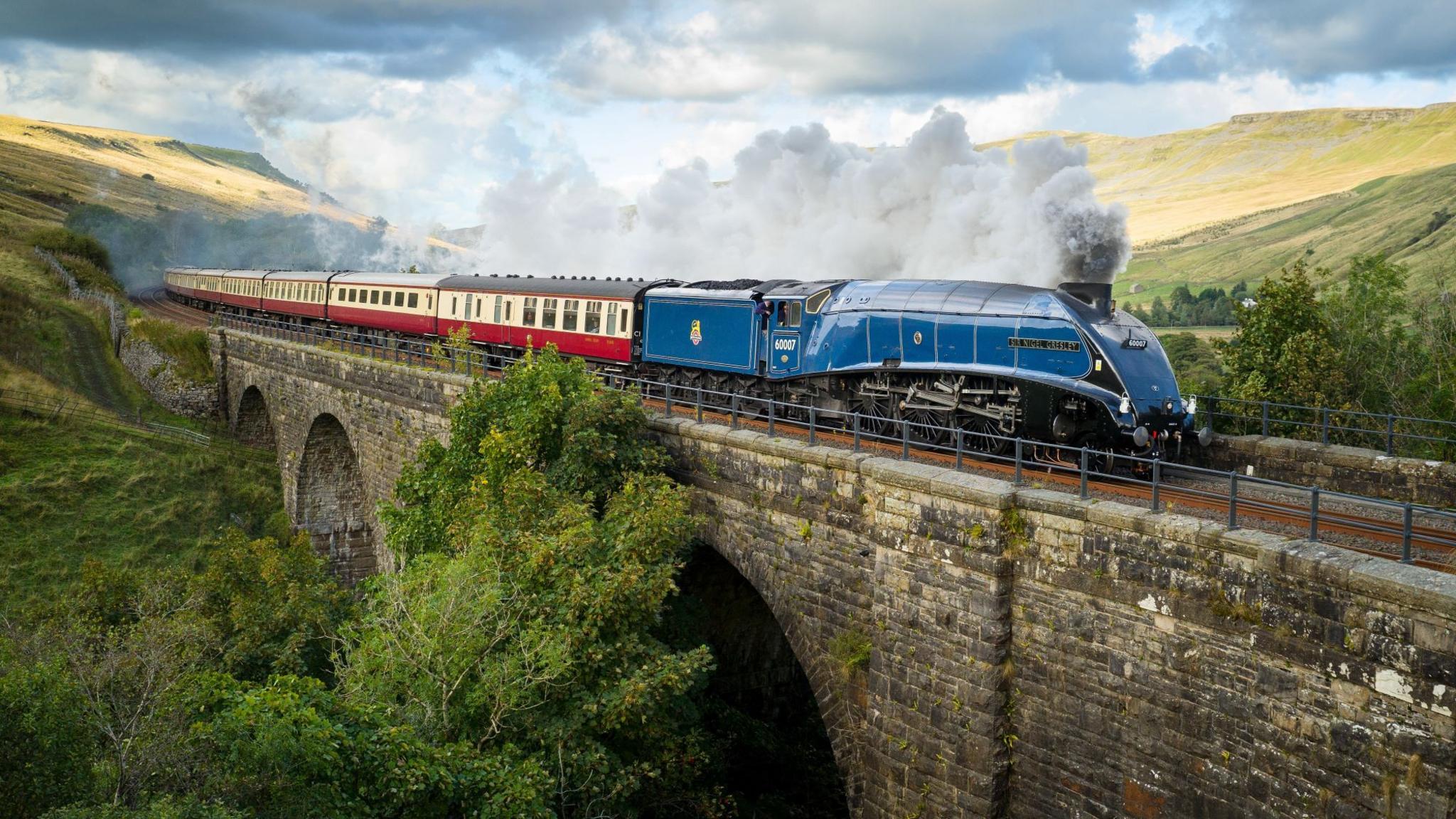 A steam locomotive crossing a viaduct