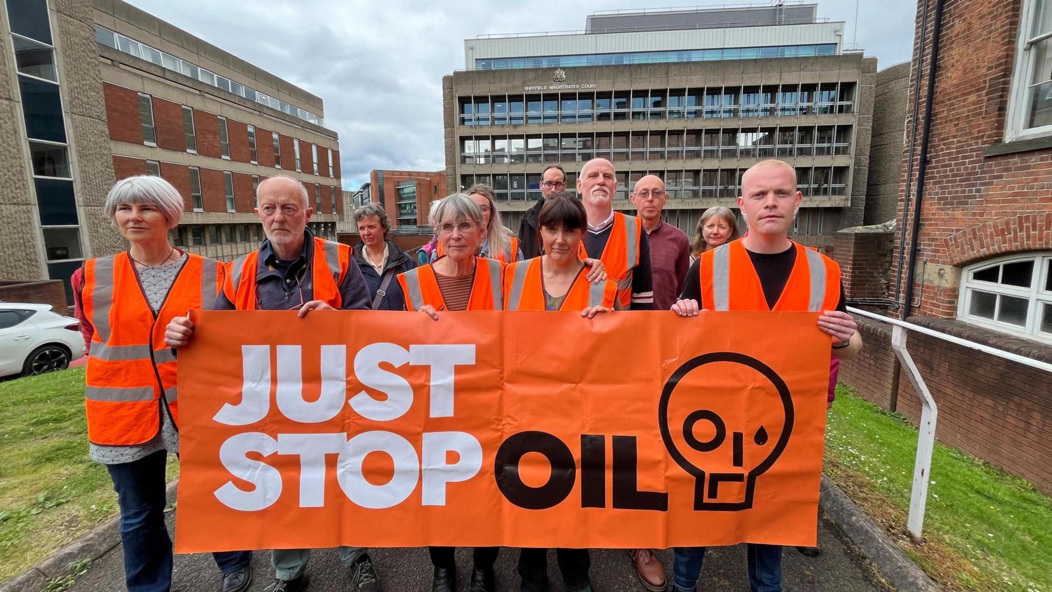 Just Stop Oil protesters with a banner outside court