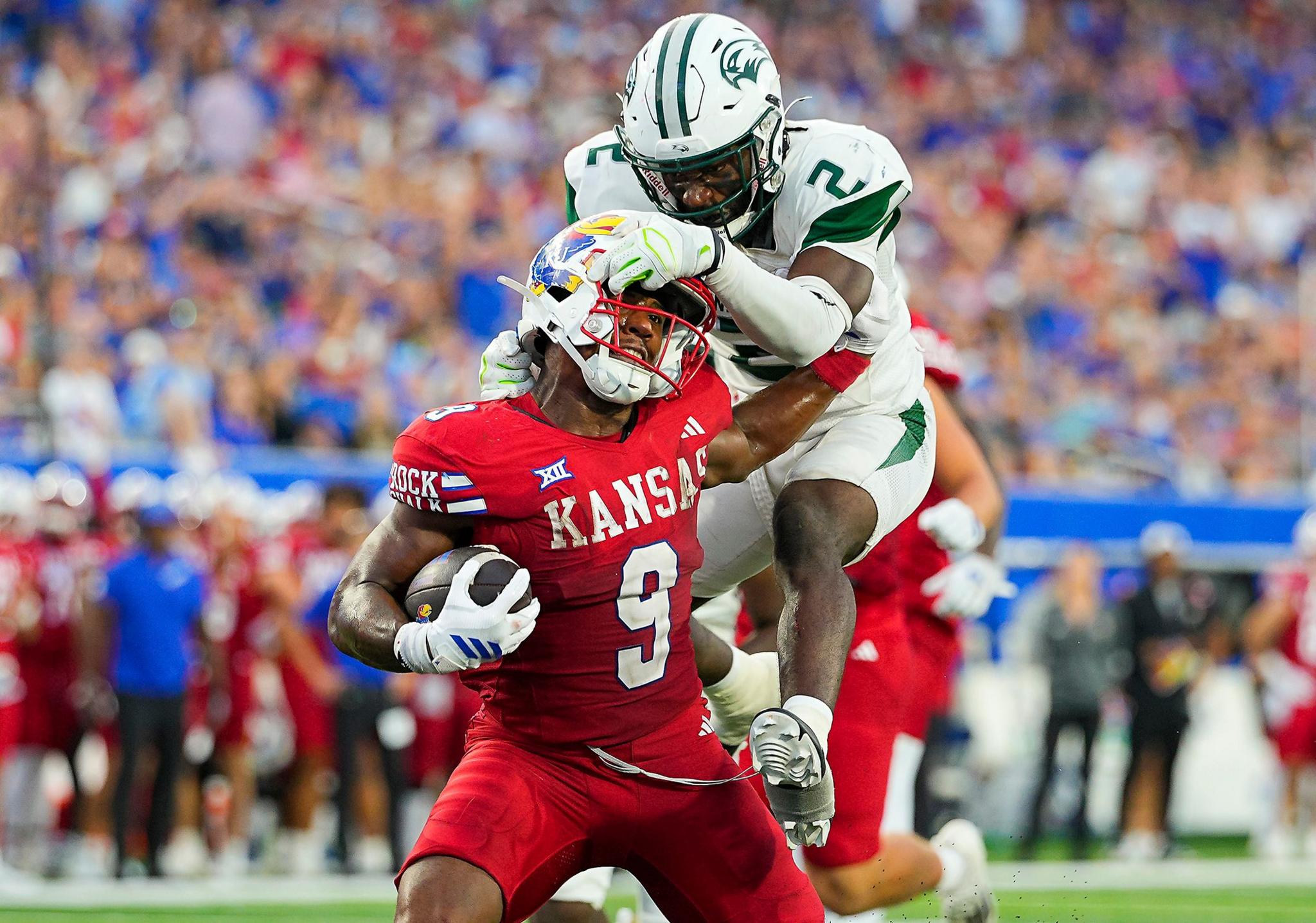 Kansas Jayhawks' Daniel Hishaw Jr. runs for a touchdown against Wagner Seahawks' Sam Martin during the first half at David Booth Kansas Memorial Stadium in Lawrence, Kansas. Photo by Jay Biggerstaff