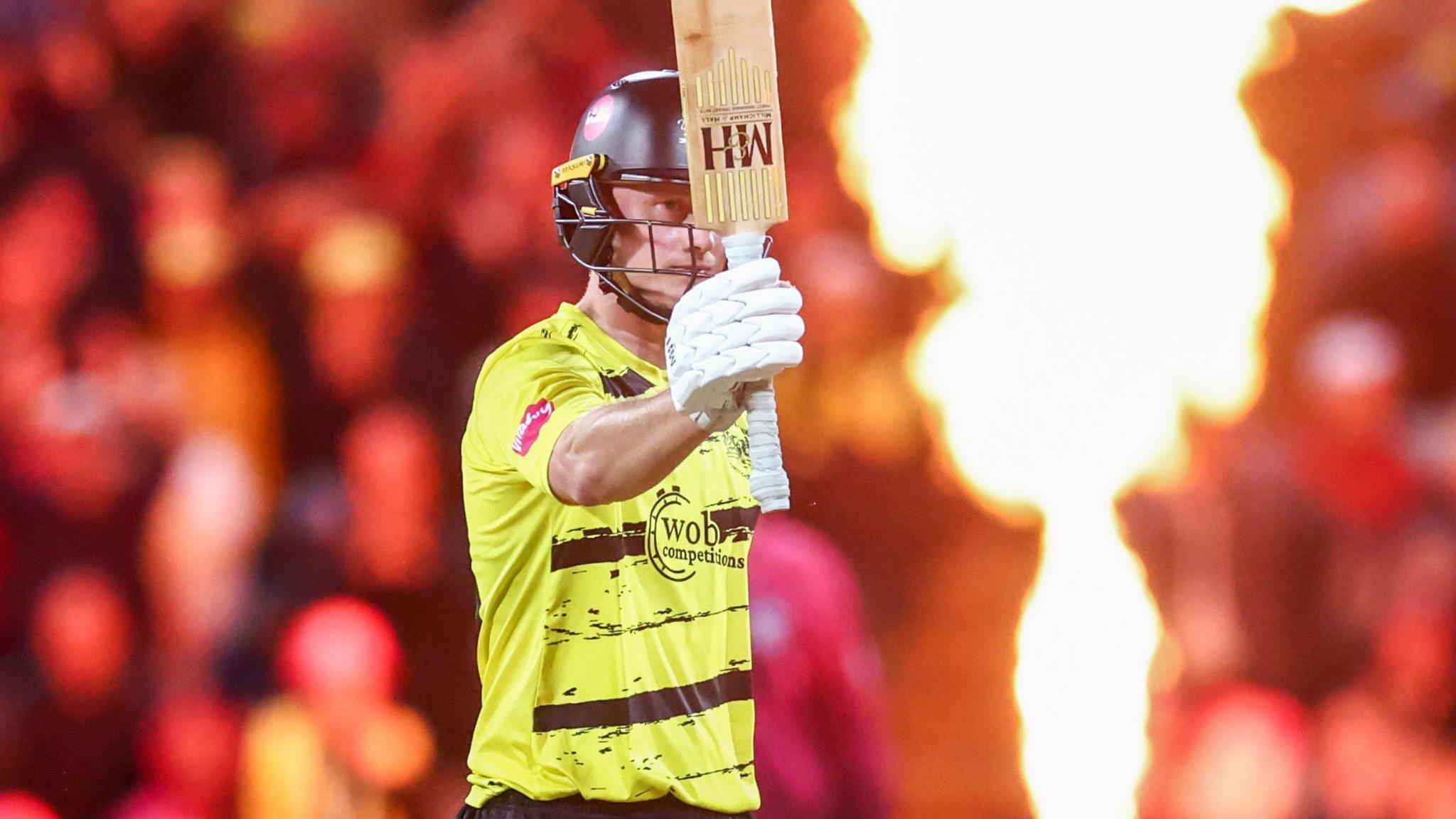 Miles Hammond holds his bat aloft on Finals Day.