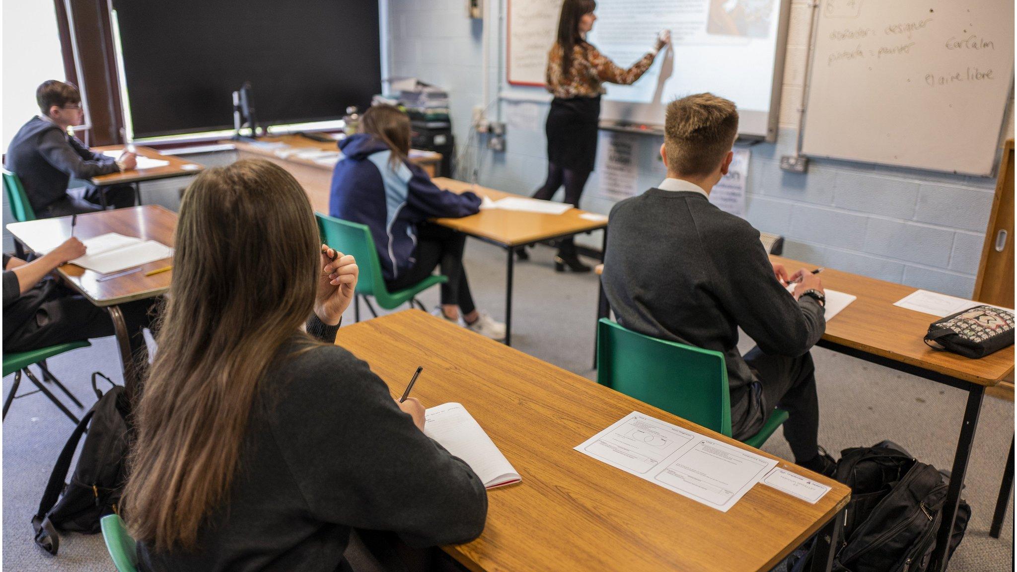 Students following social distancing rules in a language class