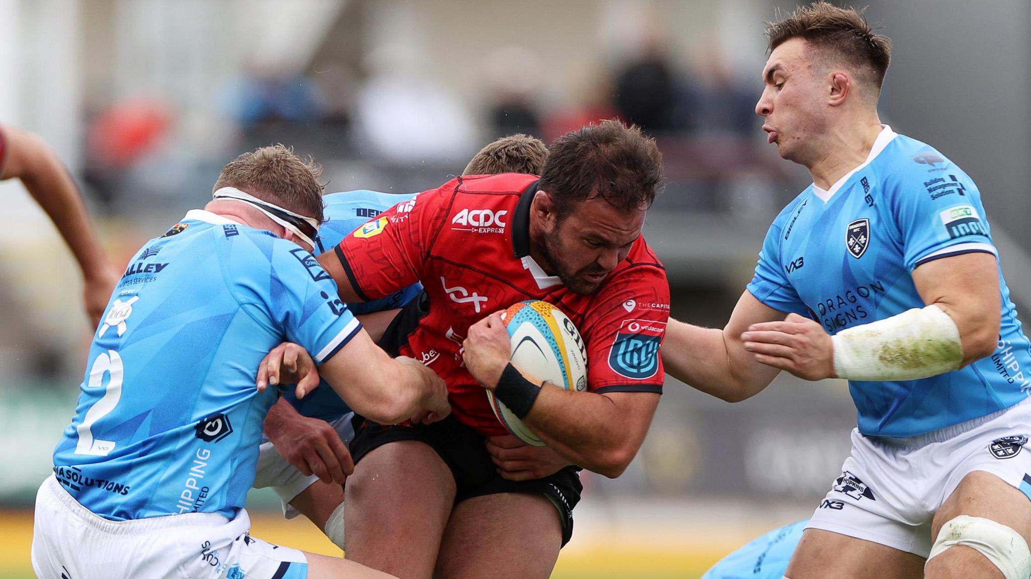 Franco Marais of Lions is tackled by Brodie Coghlan and Taine Basham of Dragons