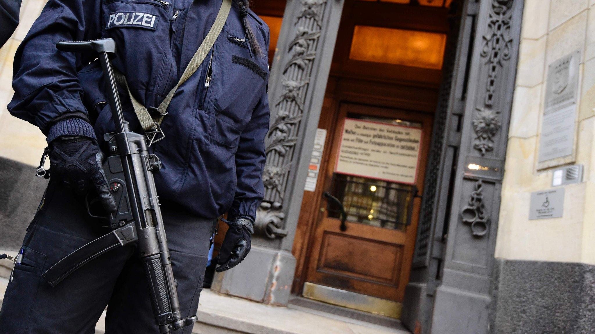 Armed police are stationed outside the Berlin court where alleged Islamic State jihadist Shaas al-M went on trial on Wednesday