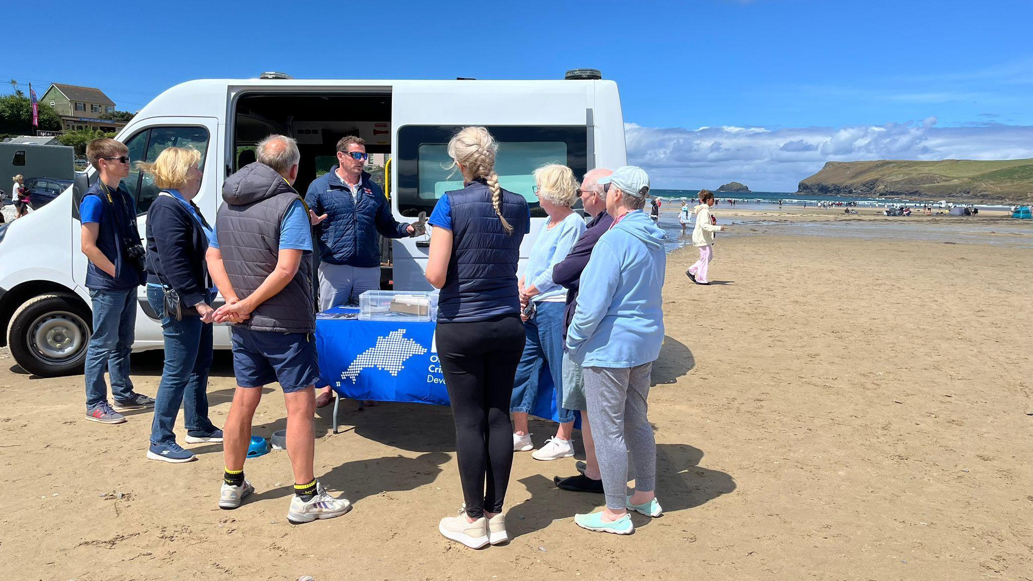 Beach rangers at Polzeath on the beach on a sunny day in summer