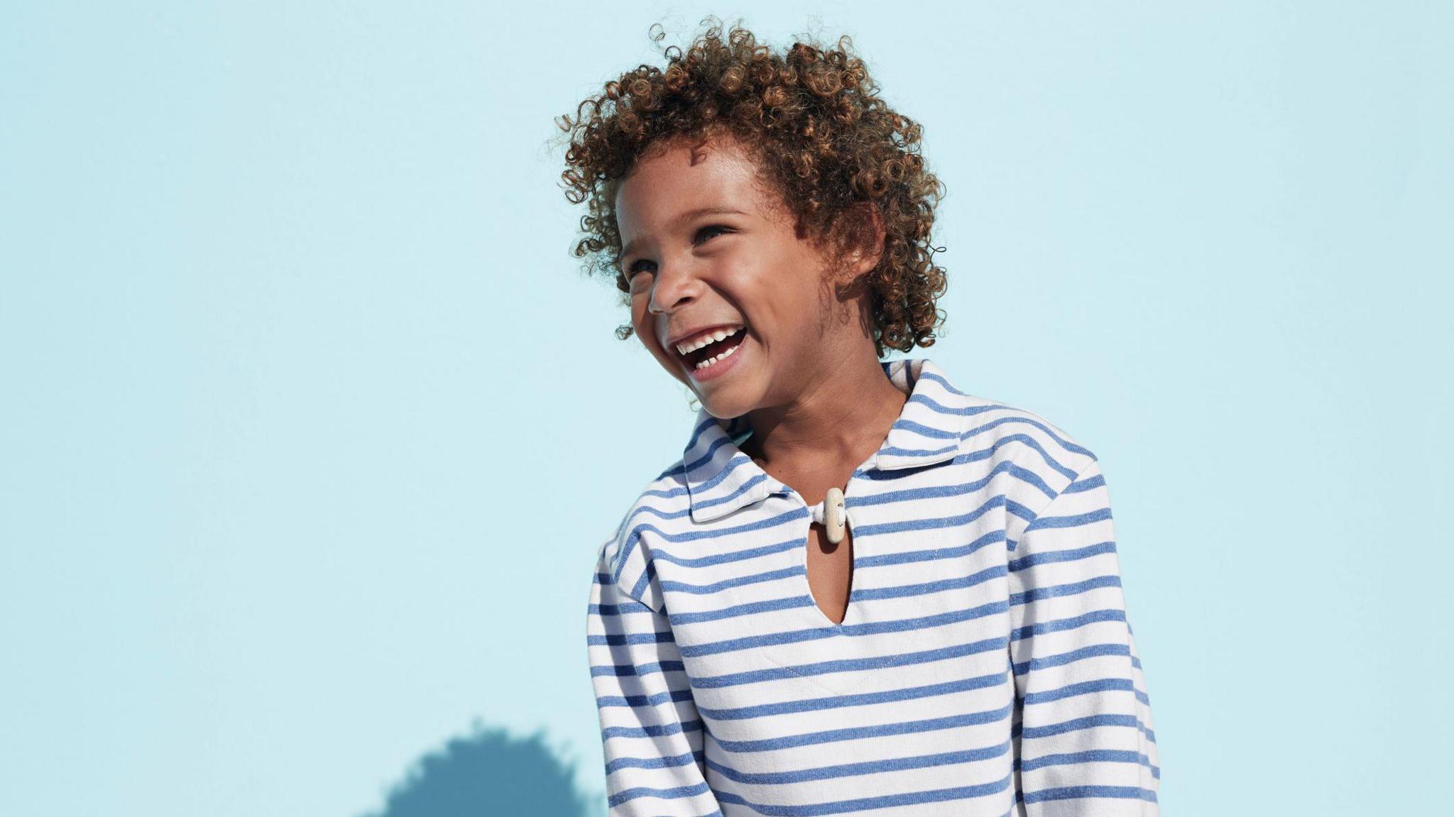 Boy laughing and looking away from the camera