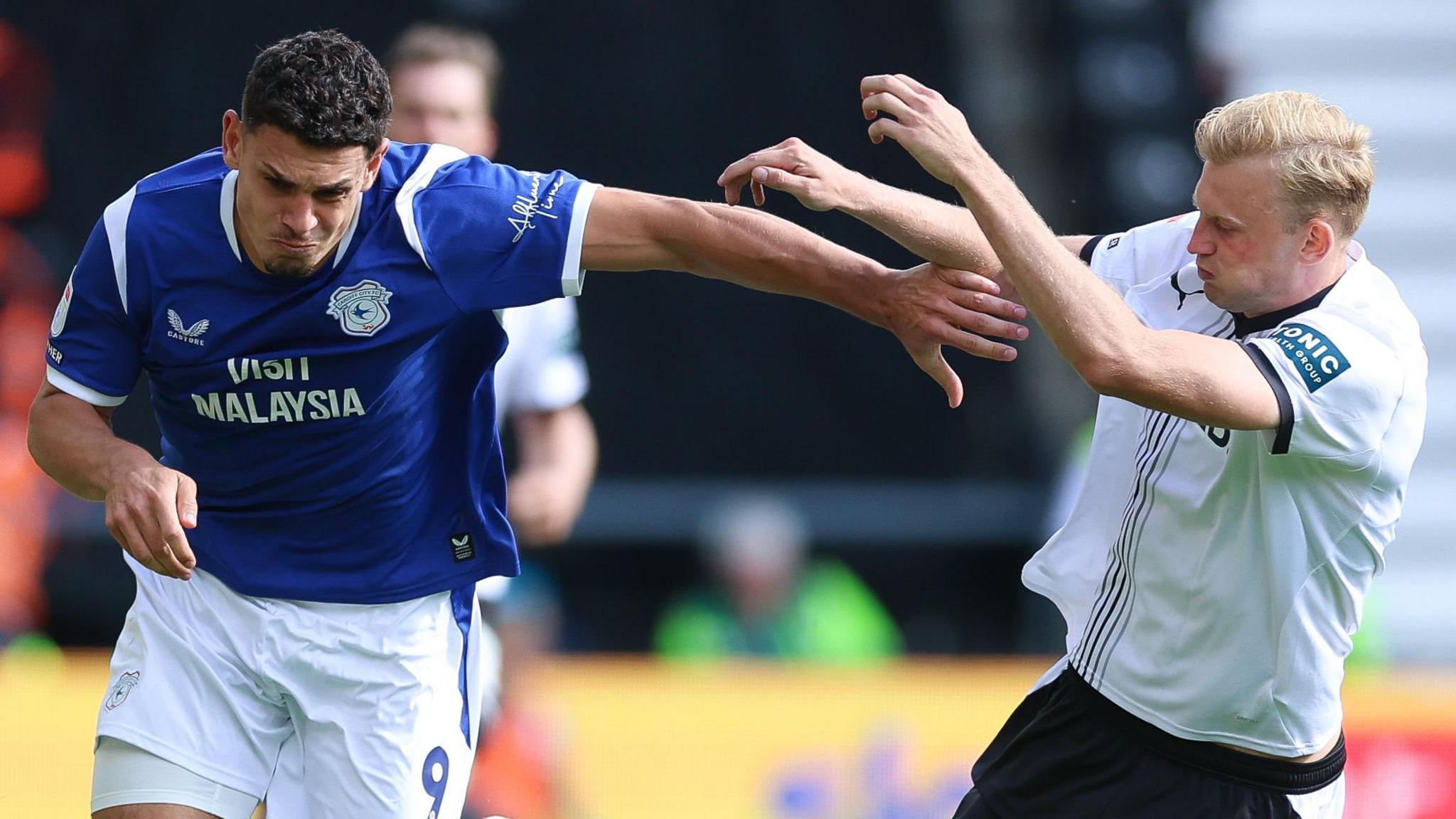 Cardiff's Yousef Salech holds off Derby defender Sondre Klingen Langås