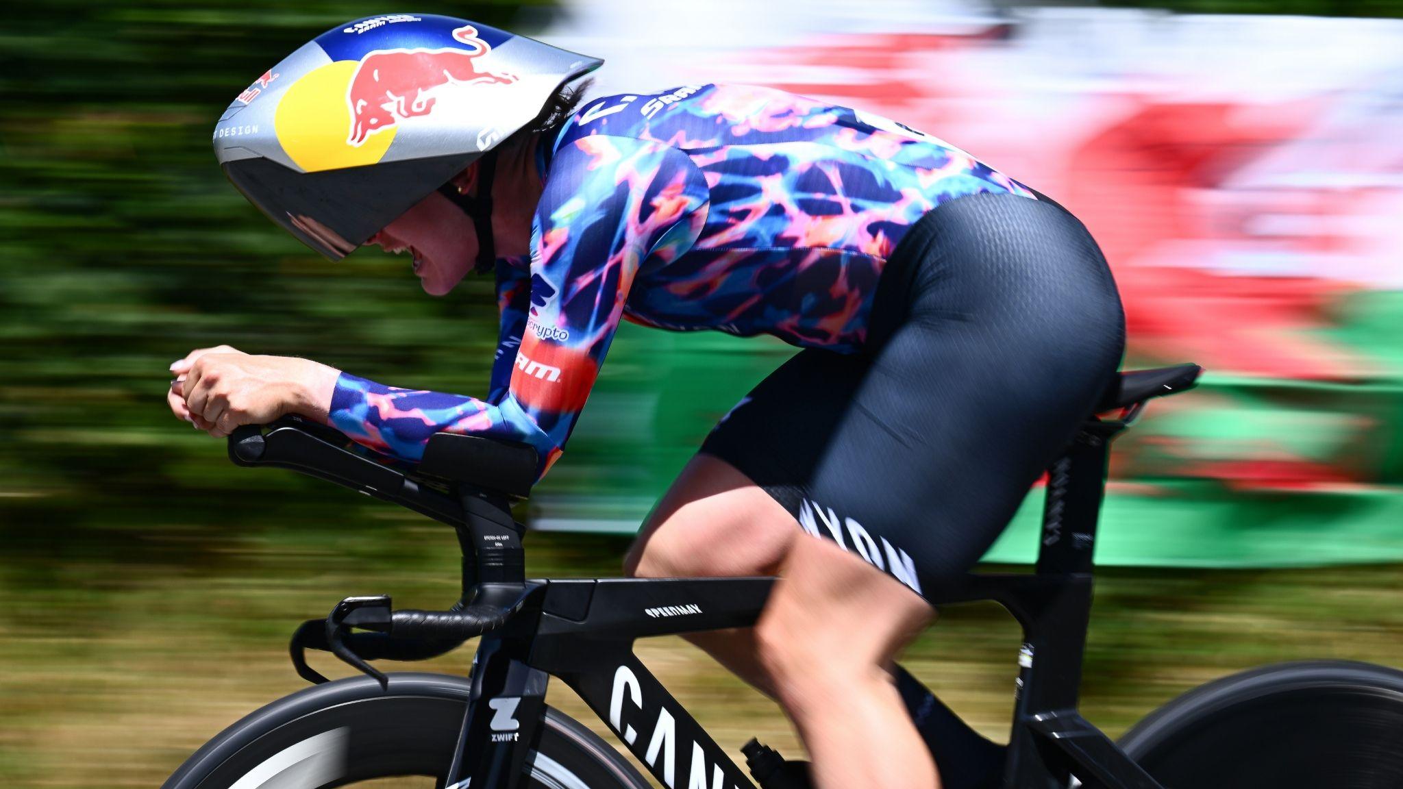 Zoe Backstedt rides the time trial with Wales flag in background