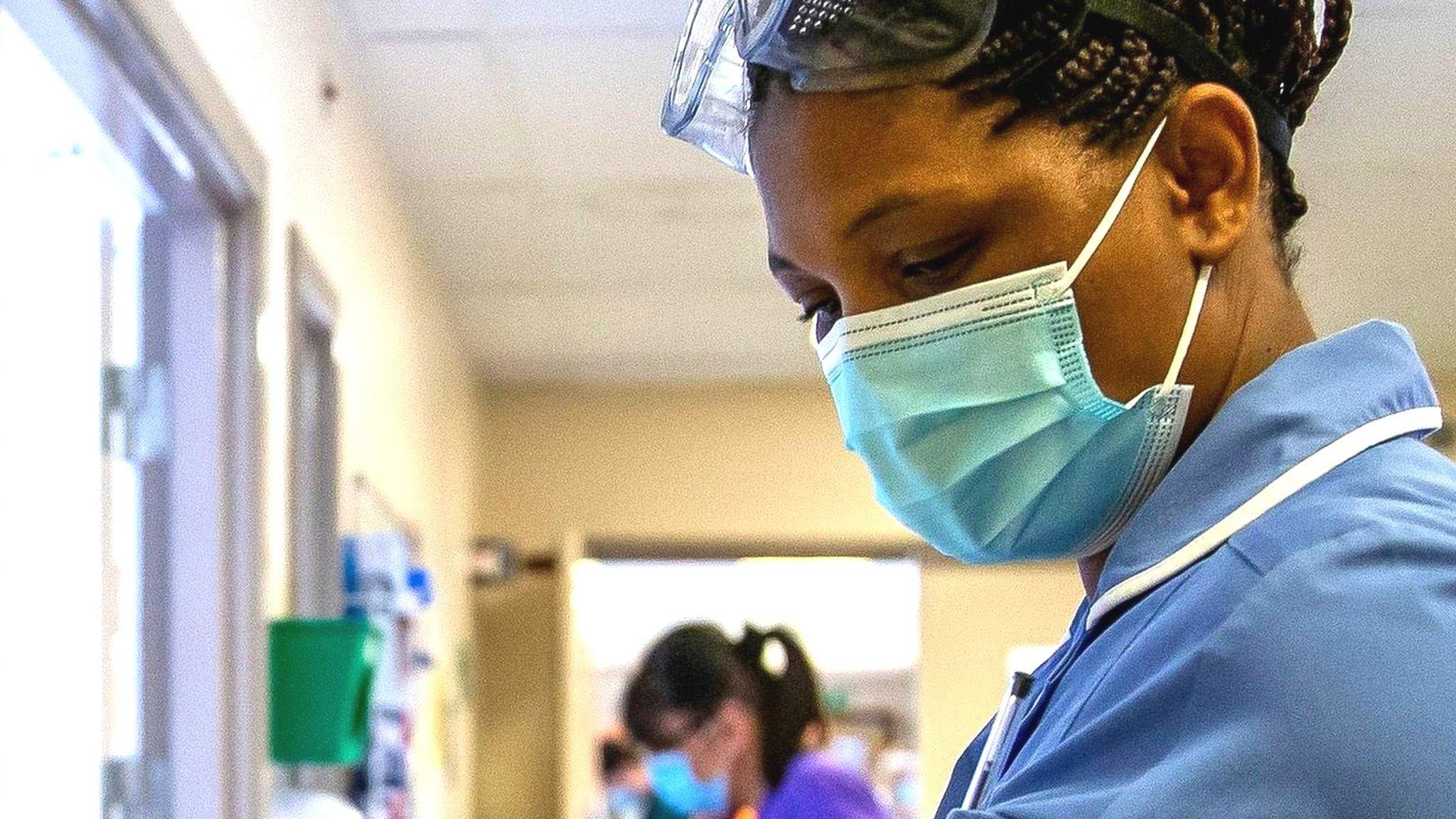 An NHS nurse updates patient records on a ward earlier this year