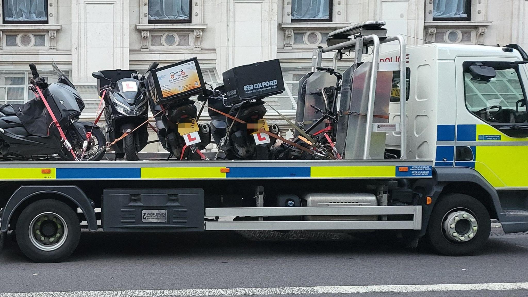 Motorbikes being towed away