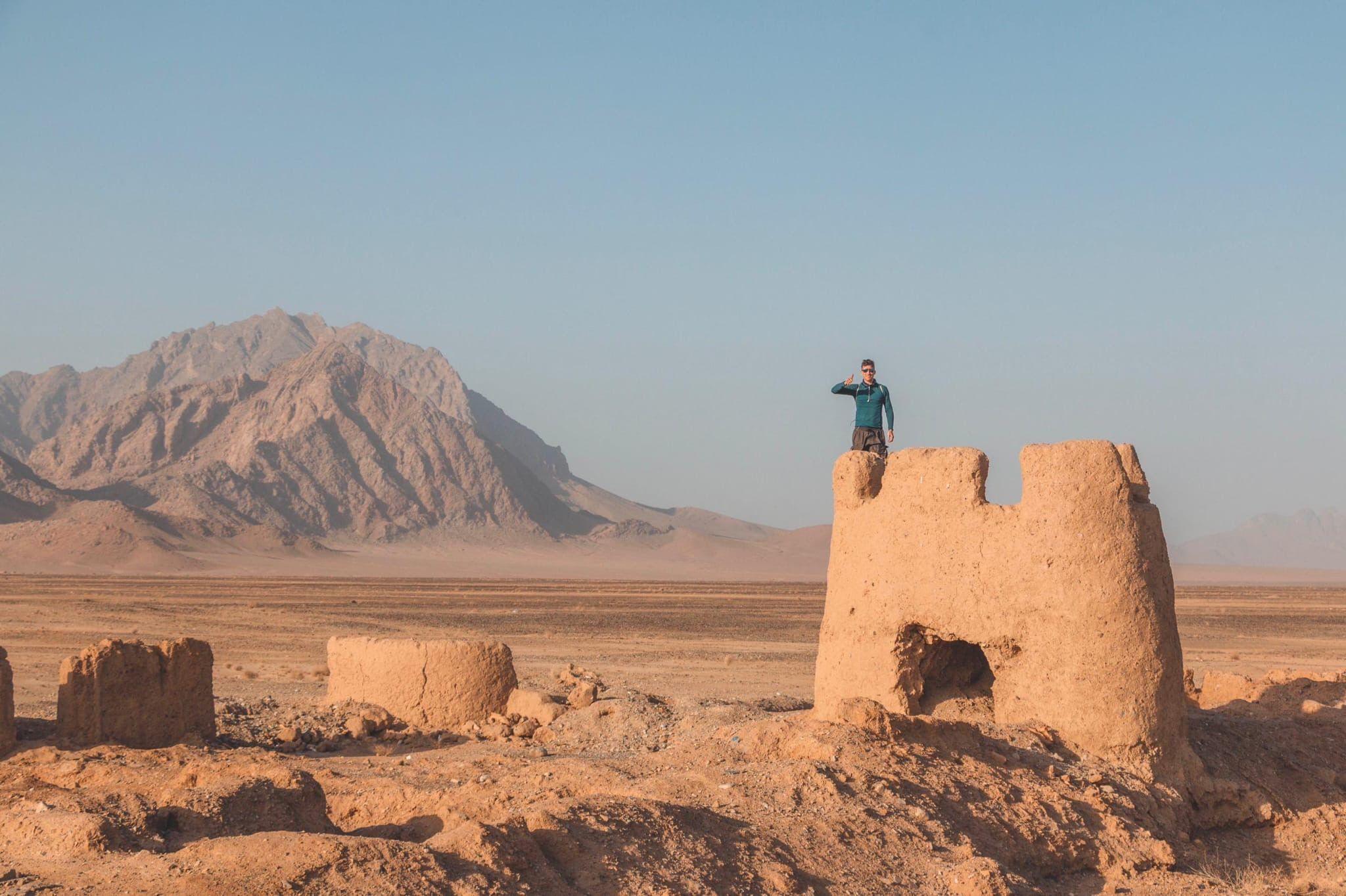 Tomas posing on top of a monument in Afghanistan