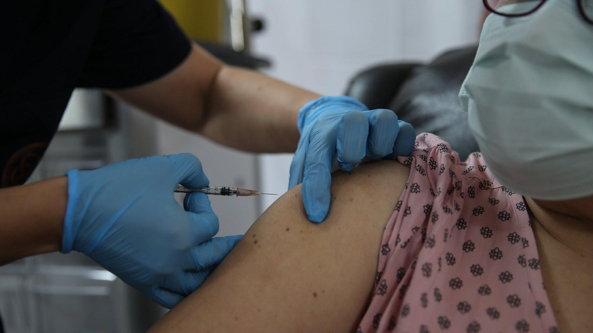 A health care worker injects the a syringe of the phase 3 vaccine trial, to a volunteer at the Ankara University Ibni Sina Hospital in Ankara, Turkey on October 27, 2020.