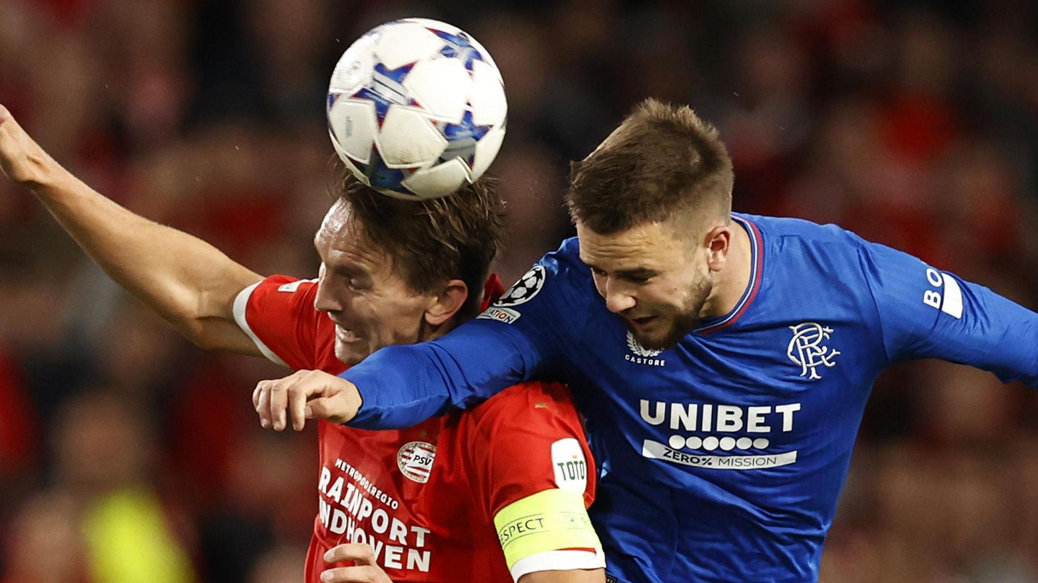 Rangers and Benfica players fight for the ball