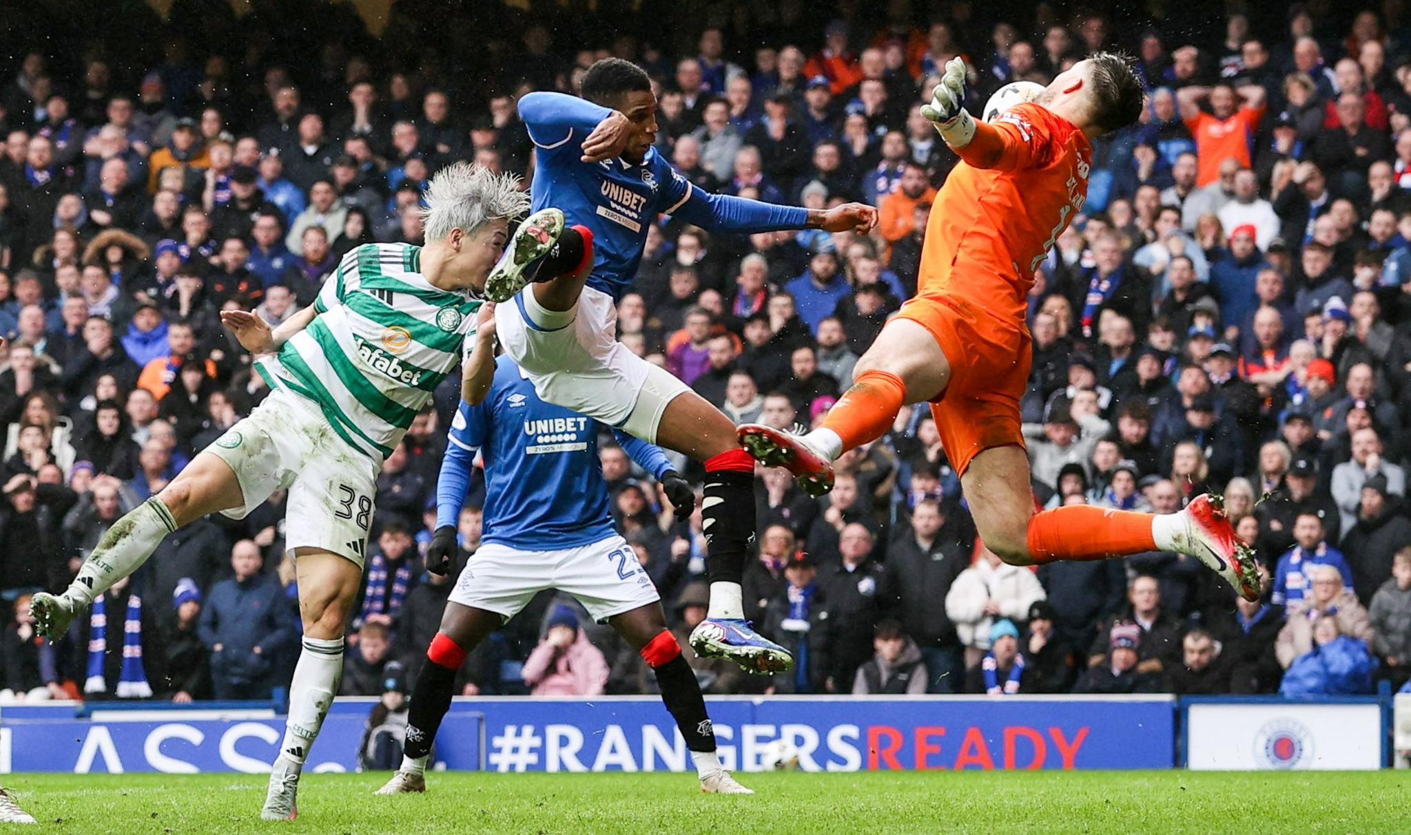 Celtic's Daizen Maeda headers the ball off Rangers defender Dujon Sterling's arm