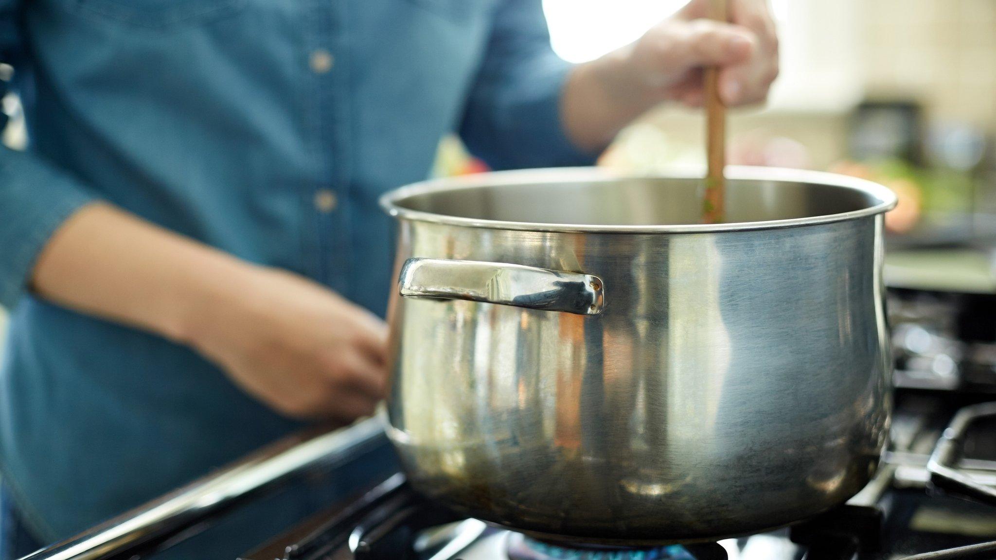 Person cooking on gas hob