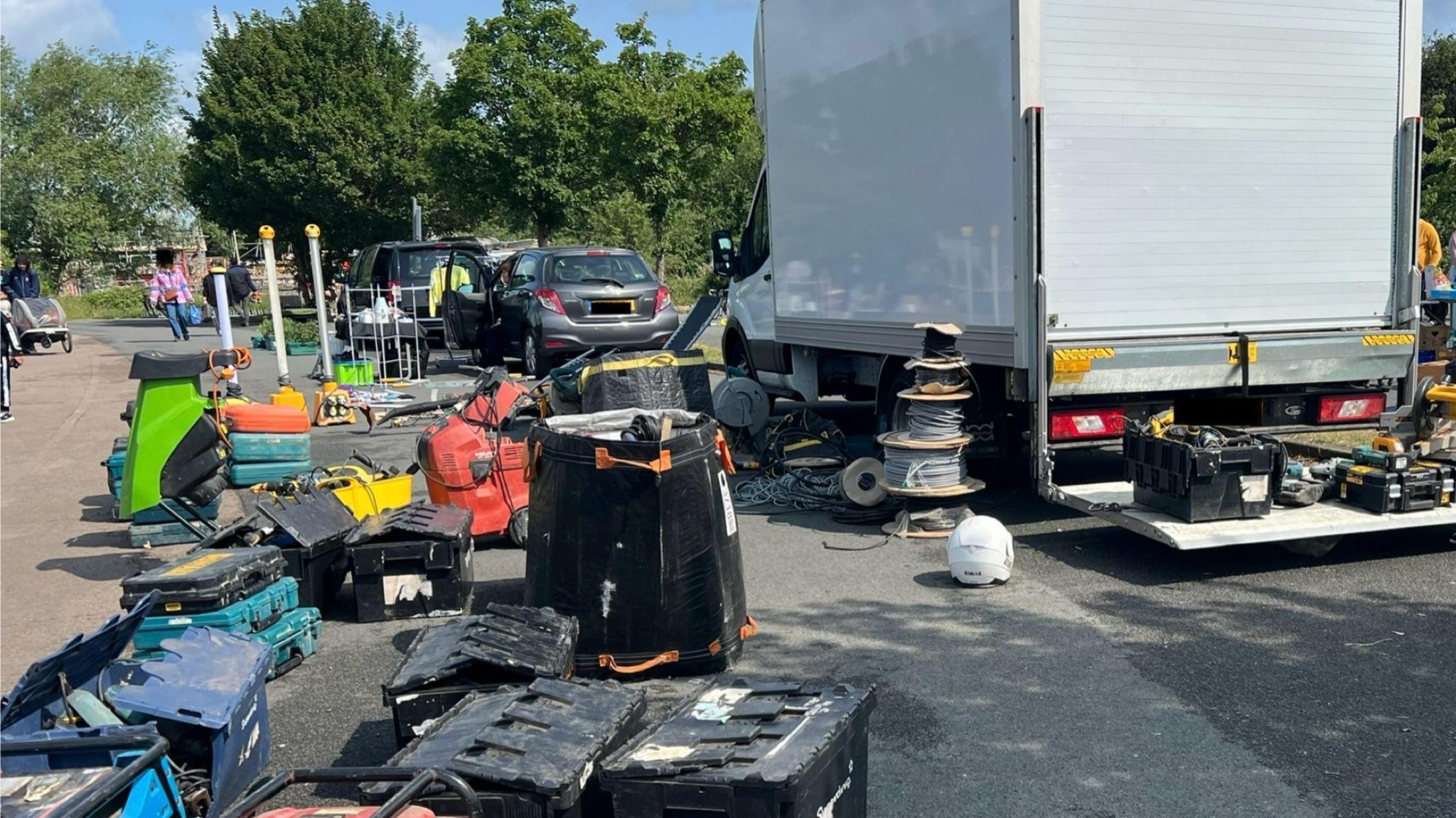 Power tools besides a van, which was recovered as part of TVP Rural Crime Taskforce action. Some people can be seen walking by.