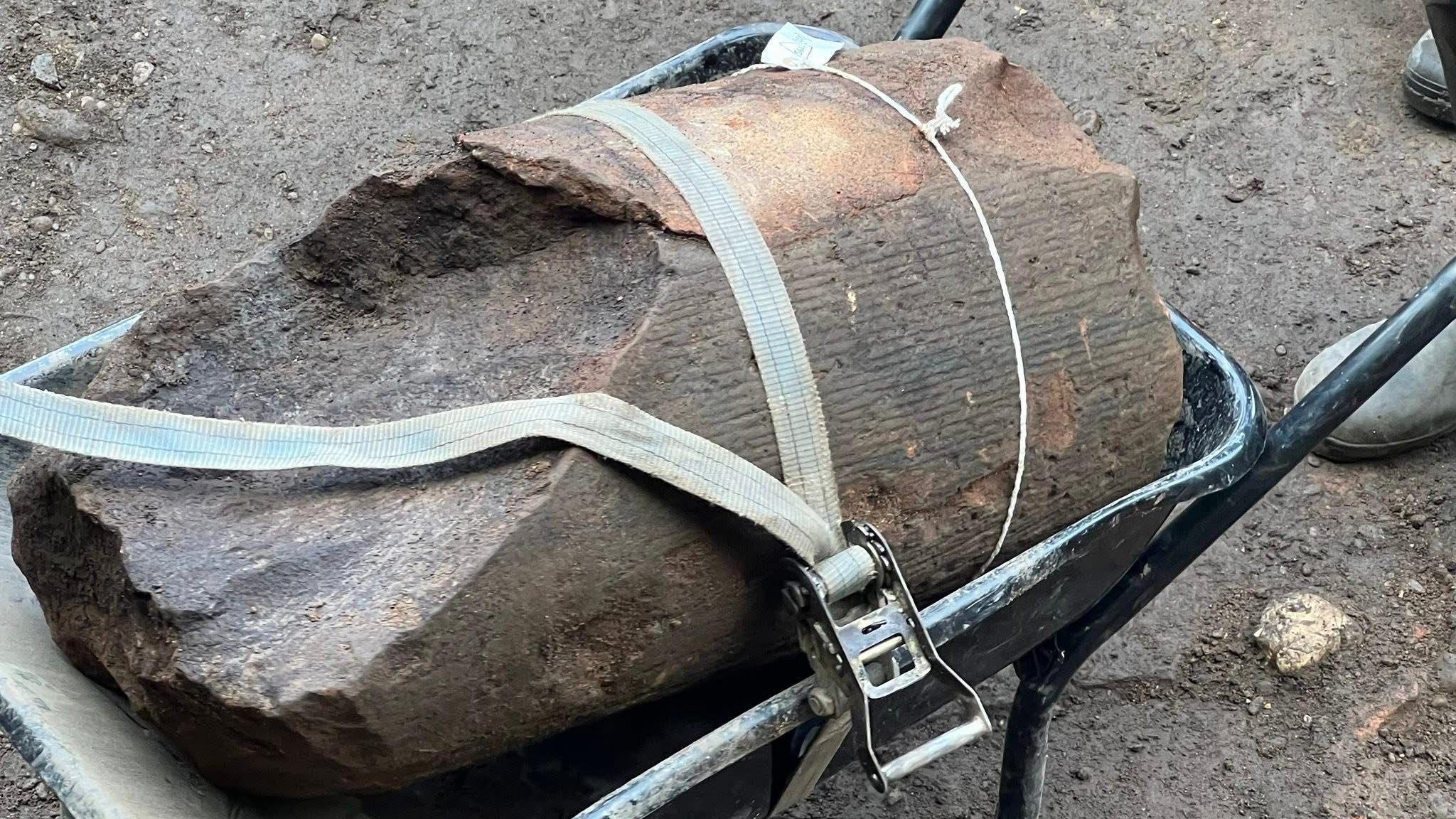A section of column found during an archaeological dig at Carlisle Cricket Club. The close-up image shows the column inside a wheelbarrow, secured with a security belt