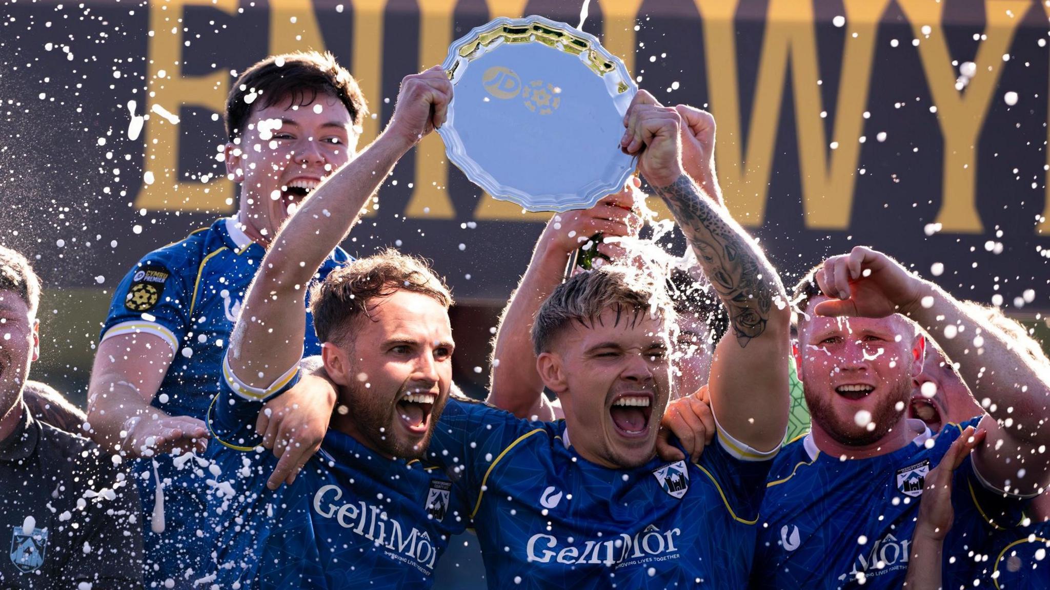 Haverfordwest players celebrate last year's play-off final win over Caernarfon