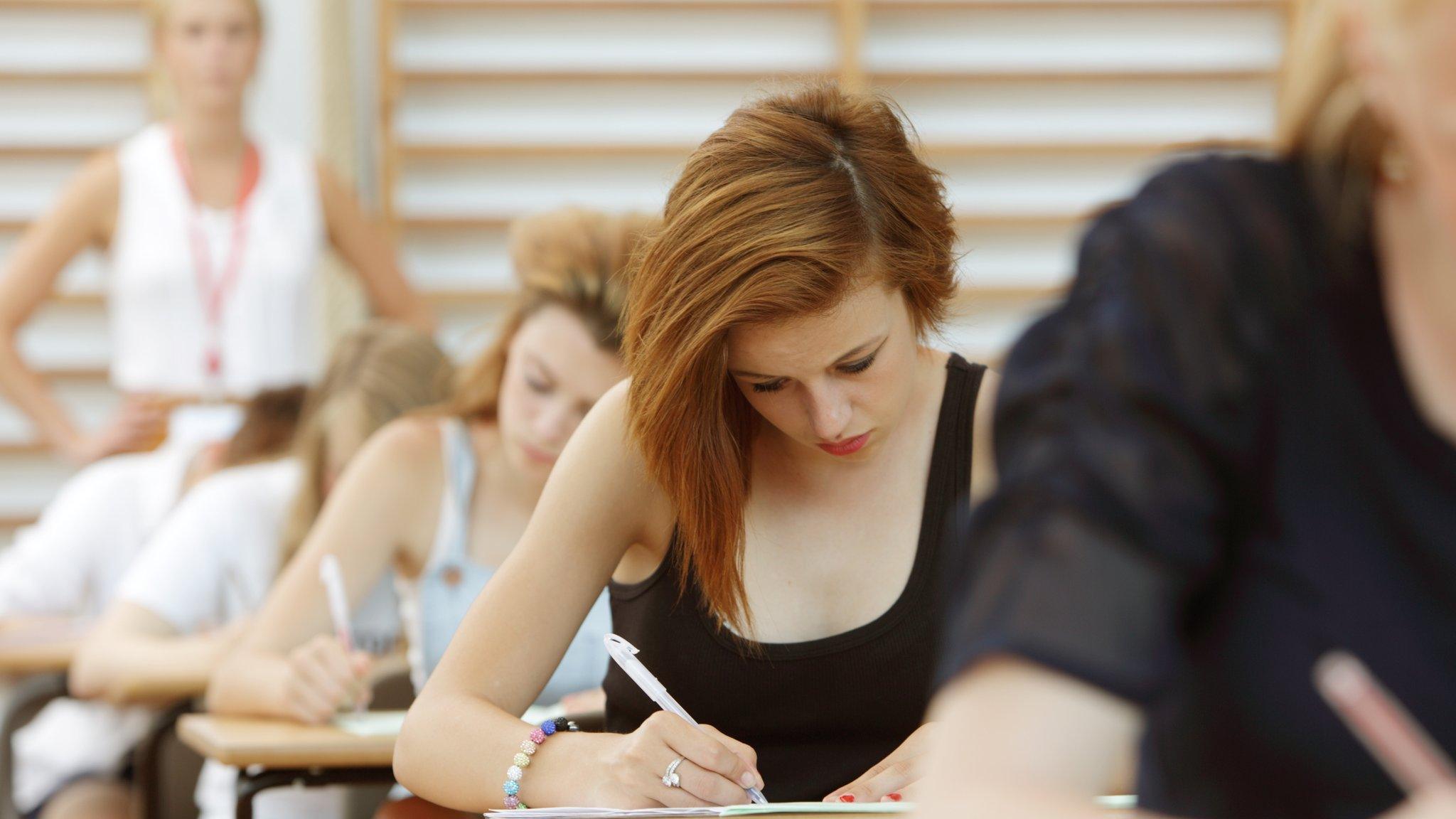 Exams hall with teacher in background