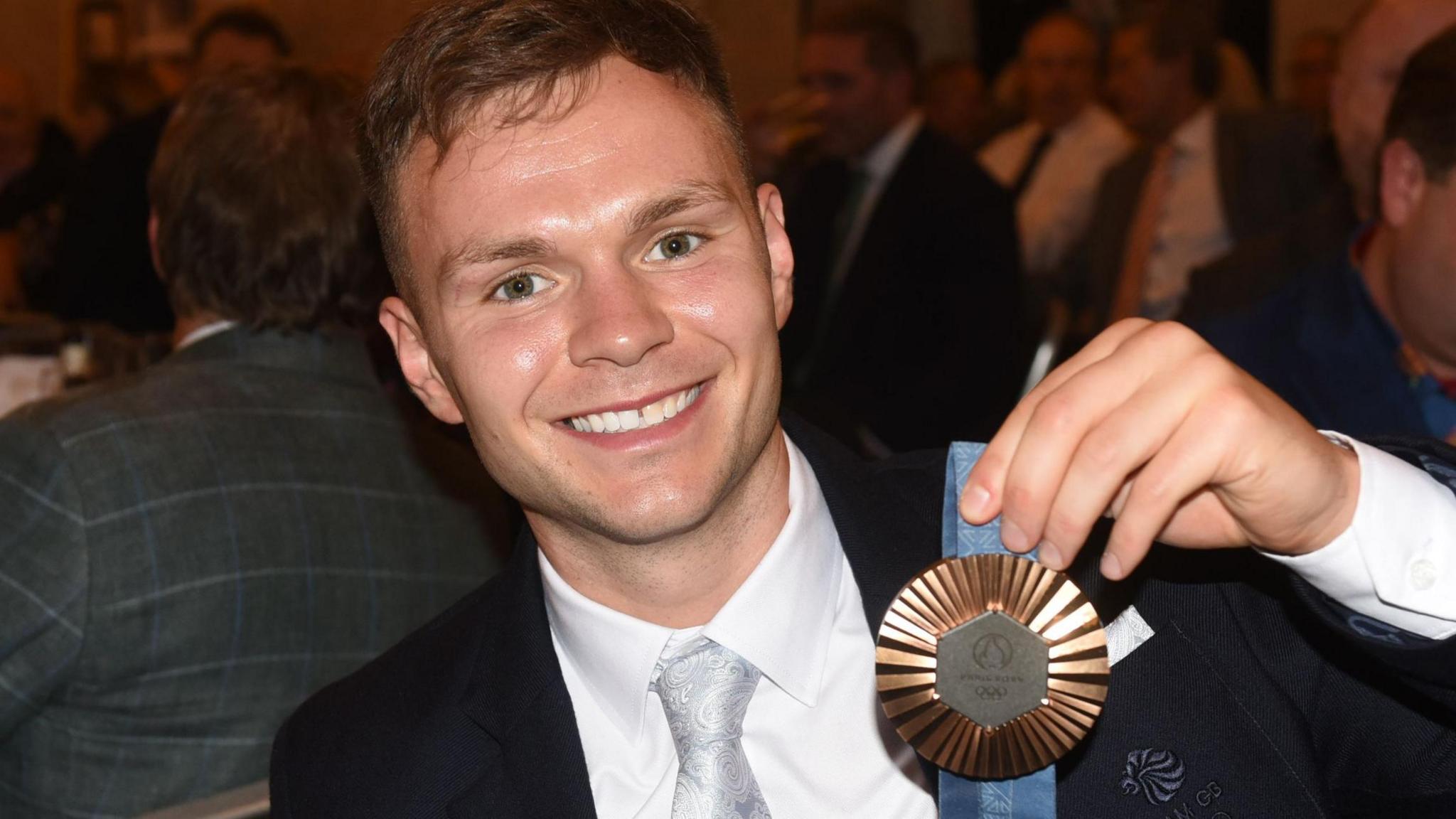 Lewis Richardson holding his Olympic medal at a tribute event for former world champion John Conteh last month