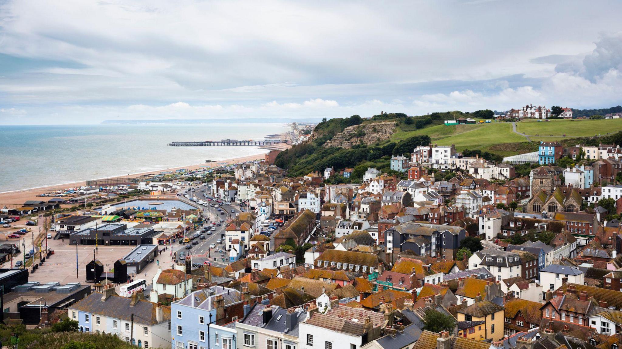 An English seaside town. It has a beach and pier.