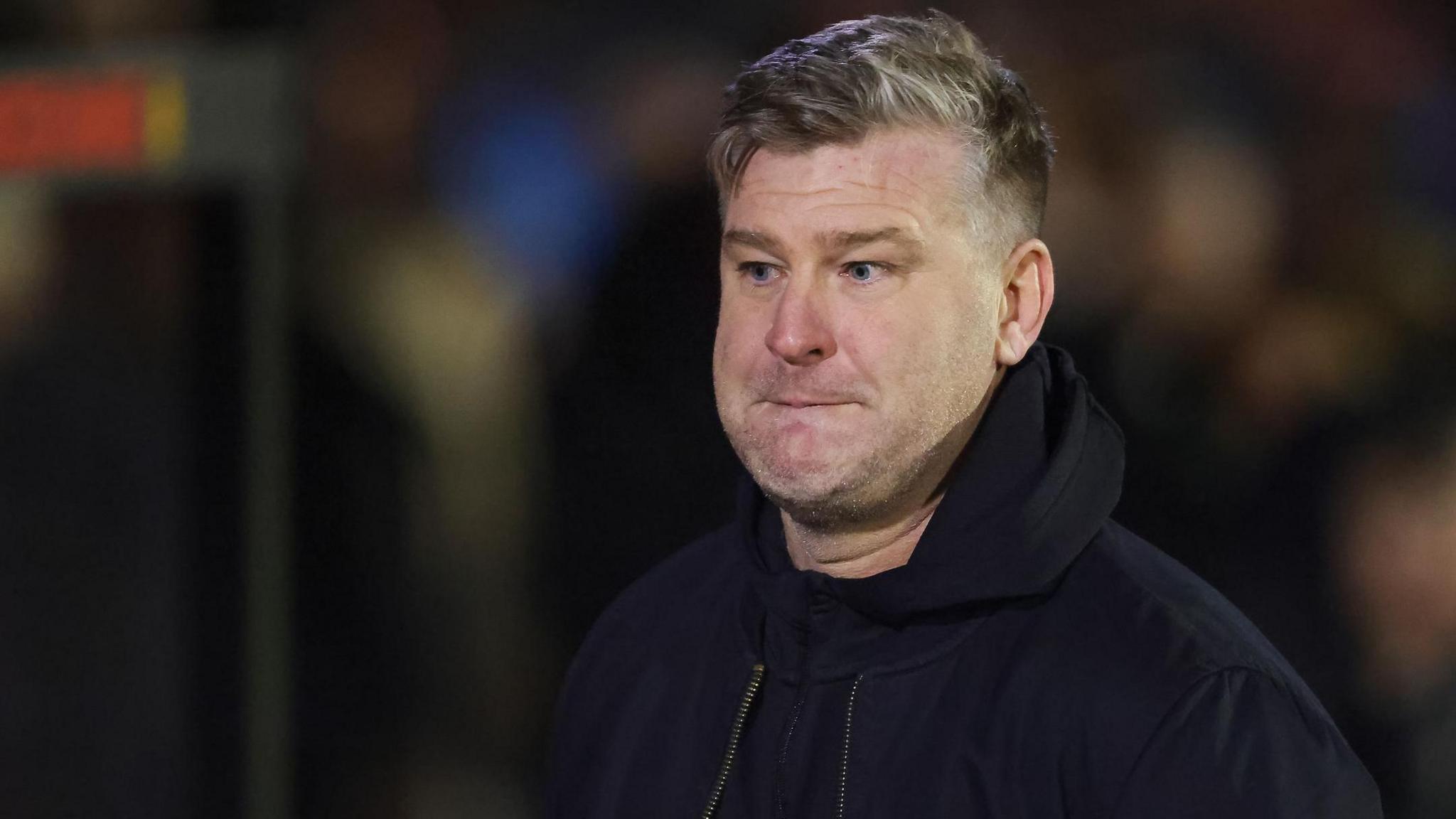 Karl Robinson looks on during Salford City' match against Grimsby Town this season