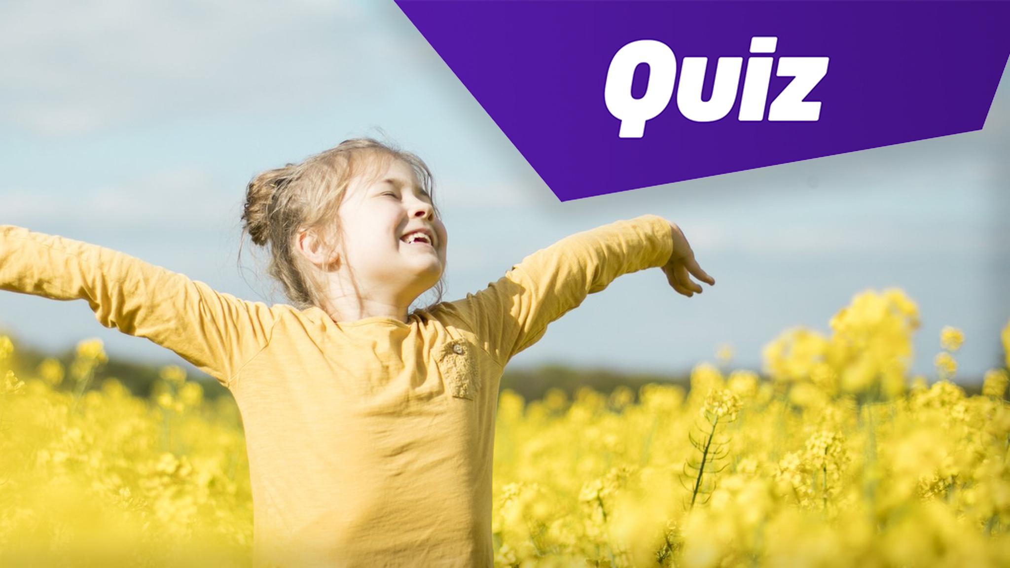 Girl standing in yellow field of flowers