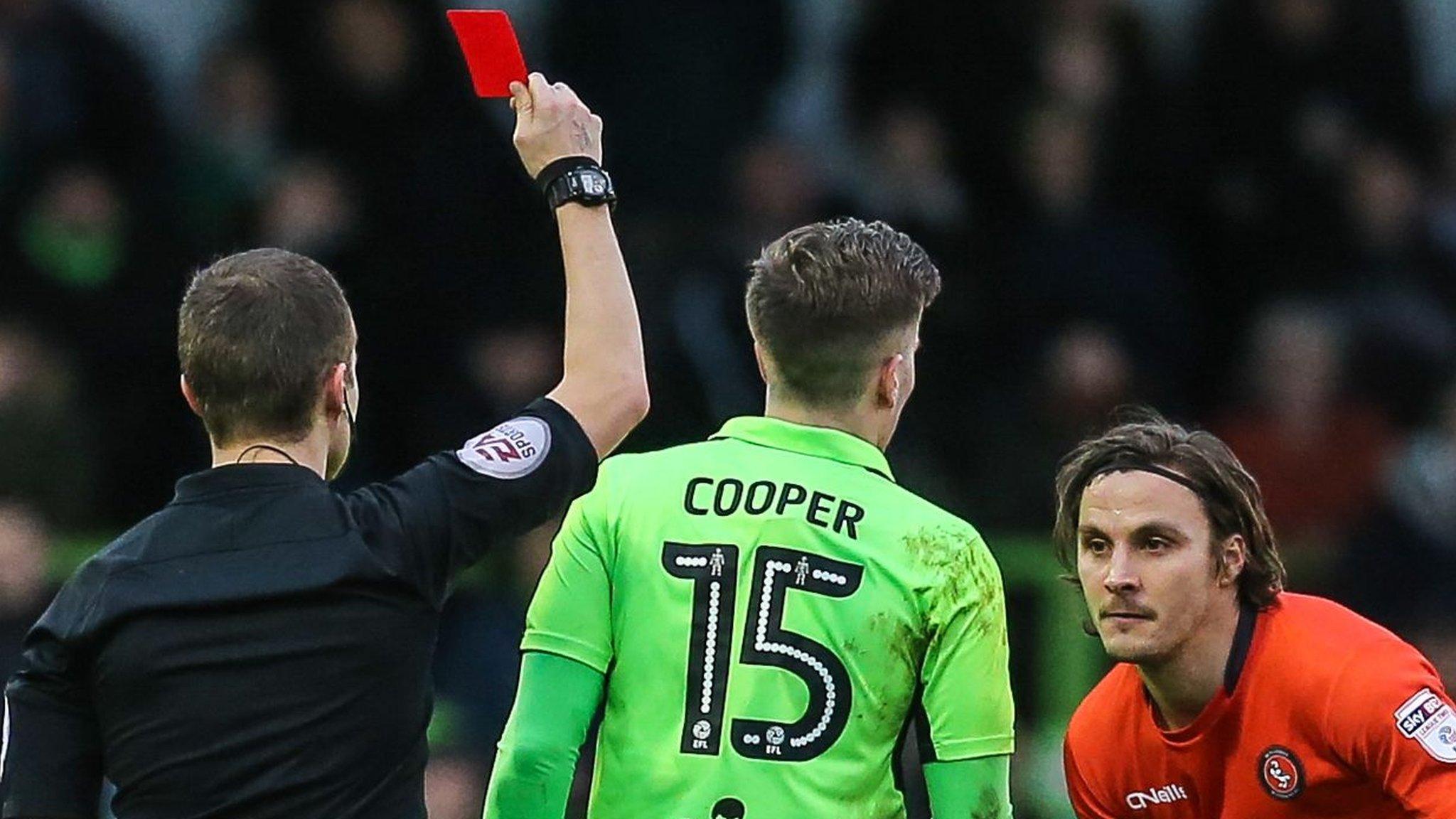 Forest Green Rovers midfielder Charlie Cooper is shown a red card against Wycombe