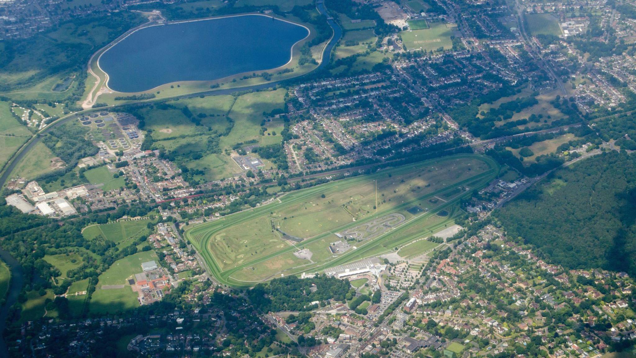 An aerial view of Esher in Surrey with the Sandown Park race course in full view plus the Island Barn Reservoir and the River Mole