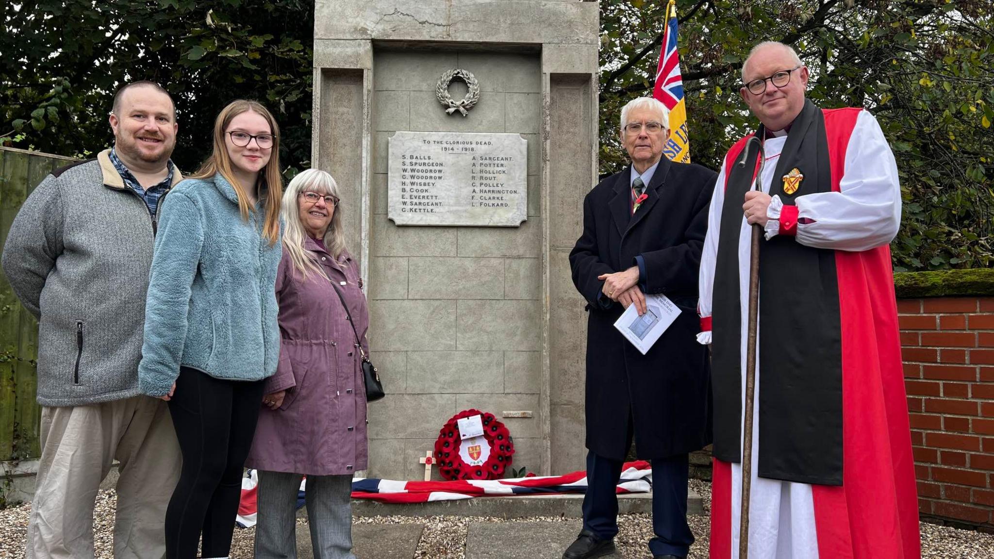 The family of Kevin Starling stand next to the war memorial in Shrub End, along with Sir Bob Russell, High Steward of Colchester, and the Bishop of Colchester, the Right Reverend Roger Morris